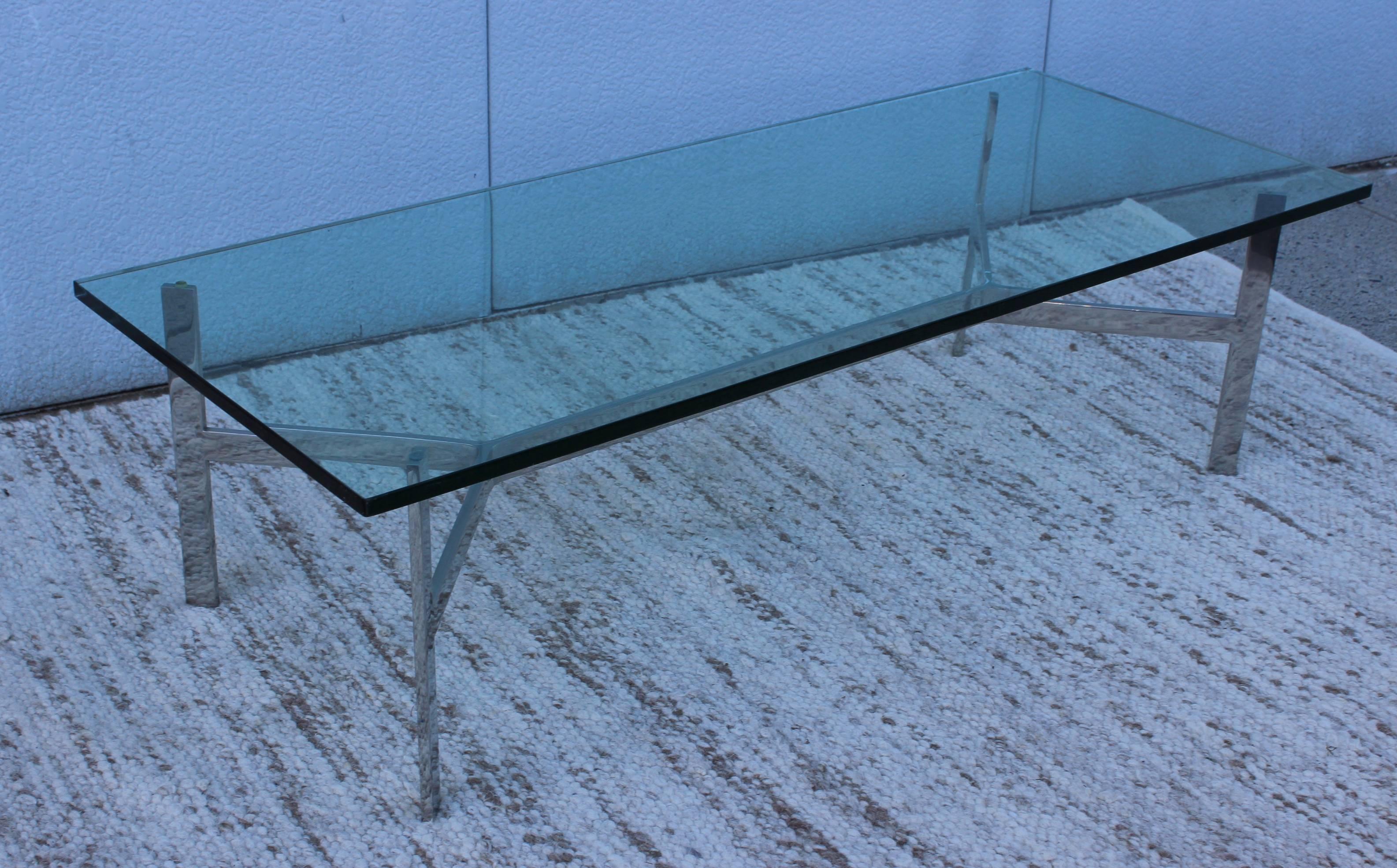 1970s modern large steel base with thick glass top coffee table.