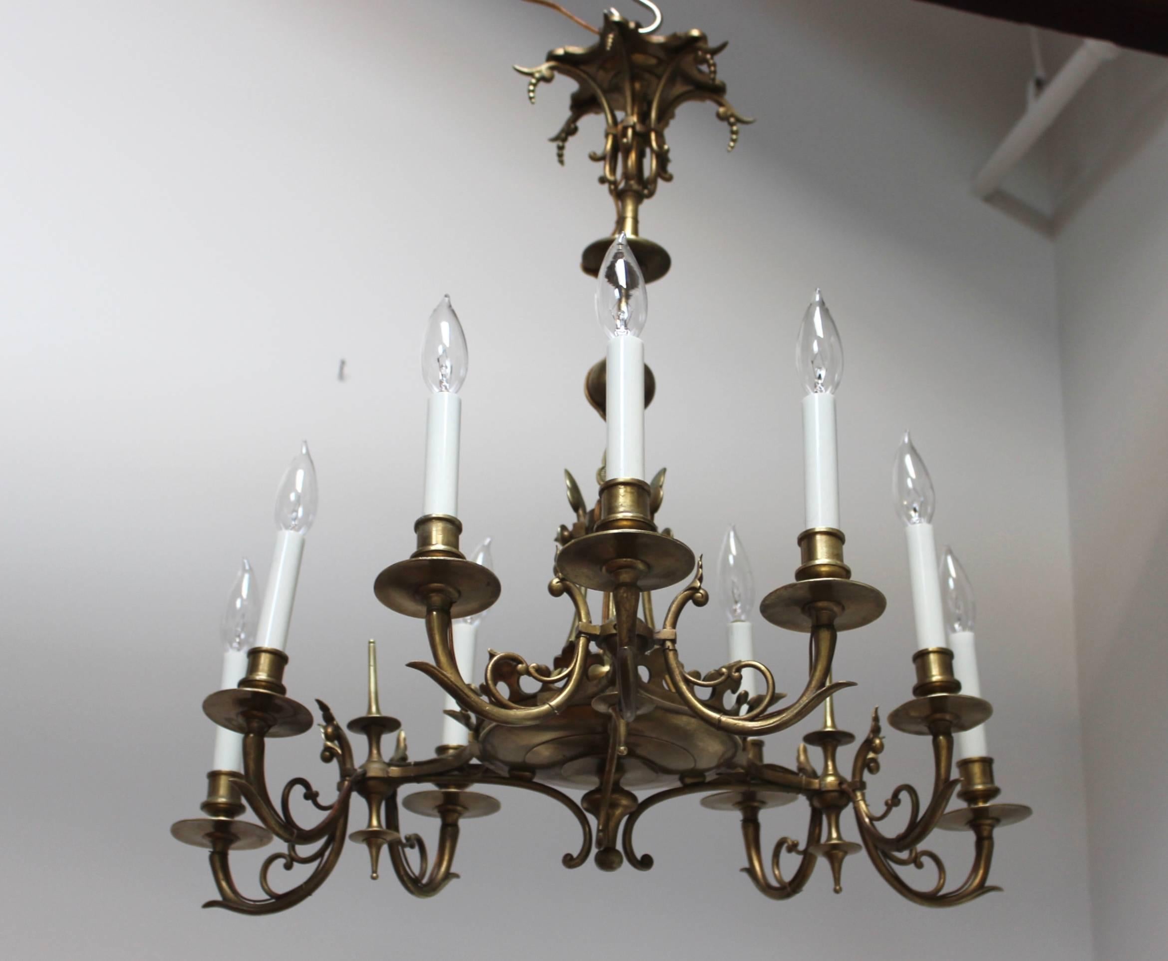 Stunning 1950s French nine lights bronze chandelier, in vintage original condition with minor wear and patina due to age and use.