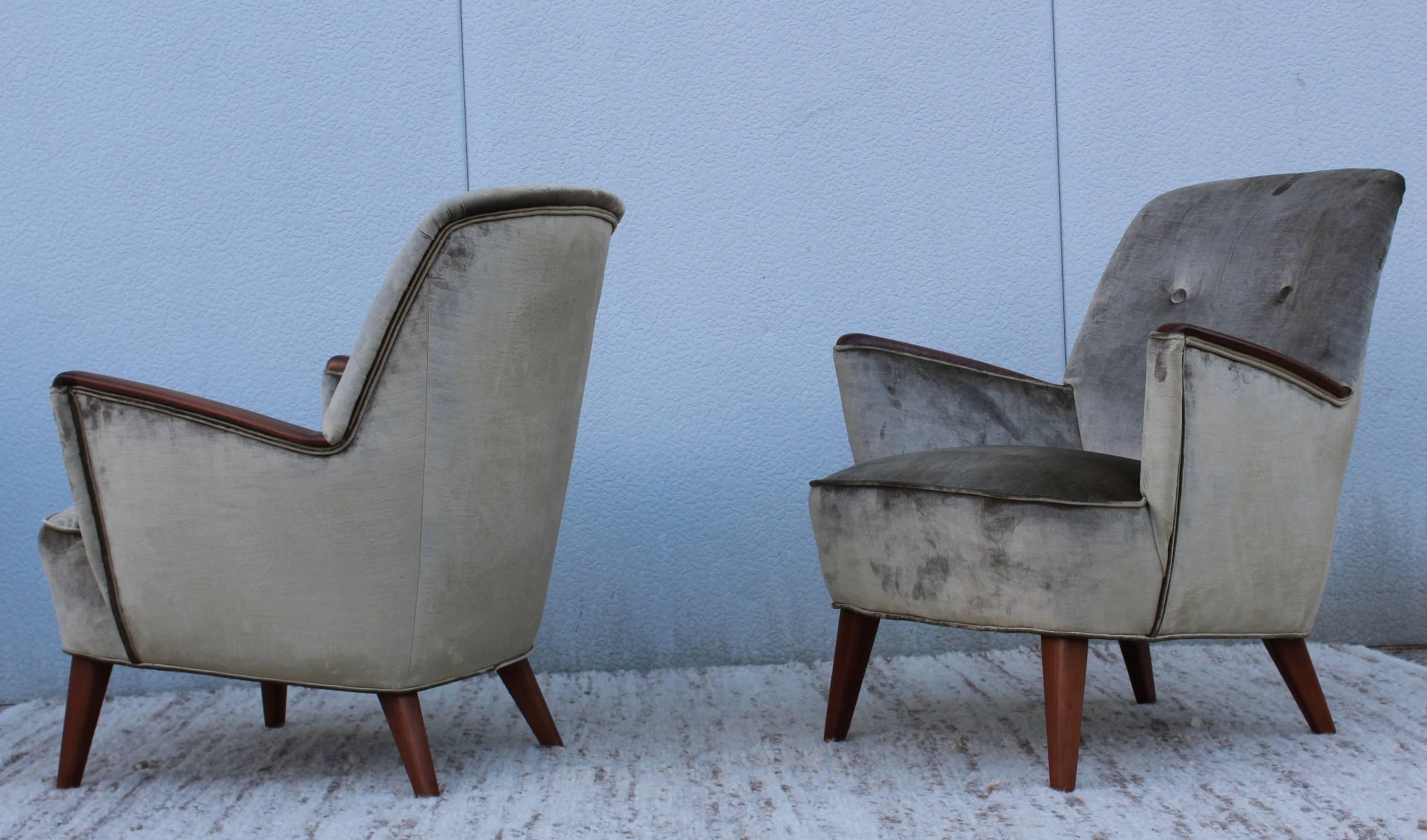 1960s modern Italian lounge chairs with walnut legs and arms. Newly upholstered in velvet.