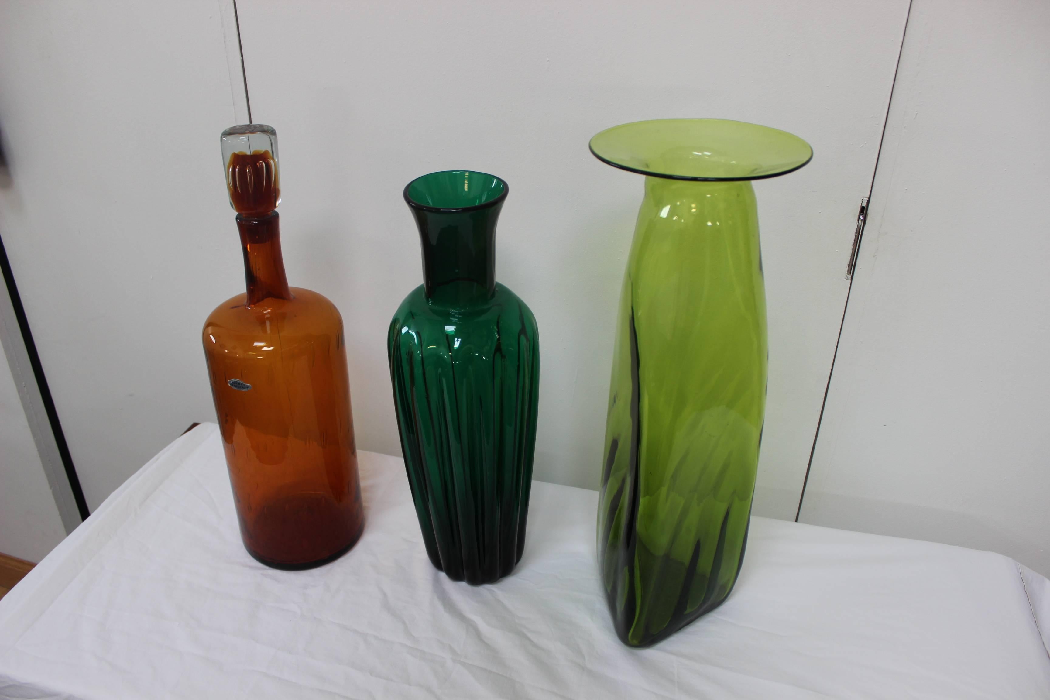 A nice set of three pieces of Blenko glass collection, the set includes two large vases and a bottle with stopper.
 
The measurements are:
Brown bottle height 21.5 diameter 6.5''.
Green vase height 22.25'' diameter 8'.
Dark green vase height