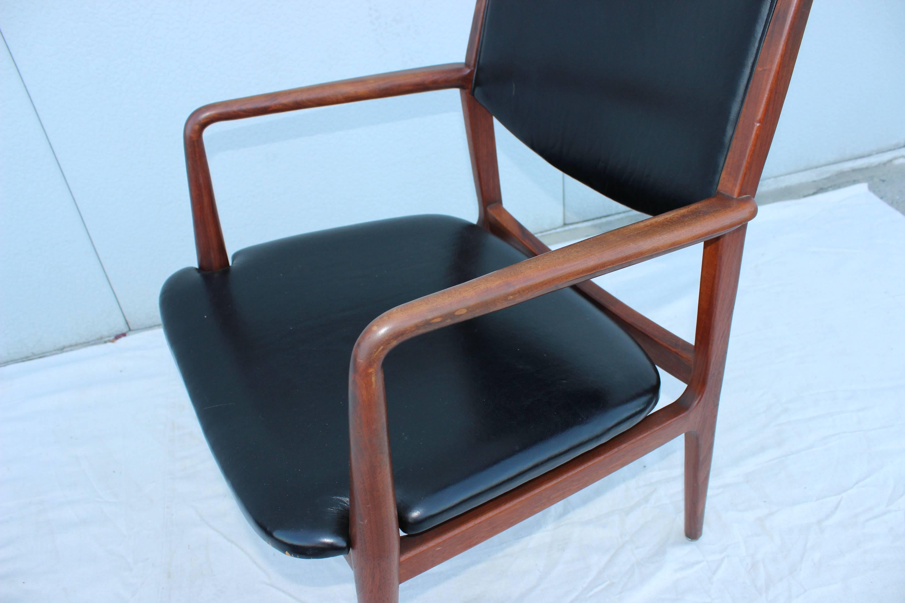 1950s leather and walnut with brass sabots modernist armchairs. Designed by George Reinoehl for Stow Davis.