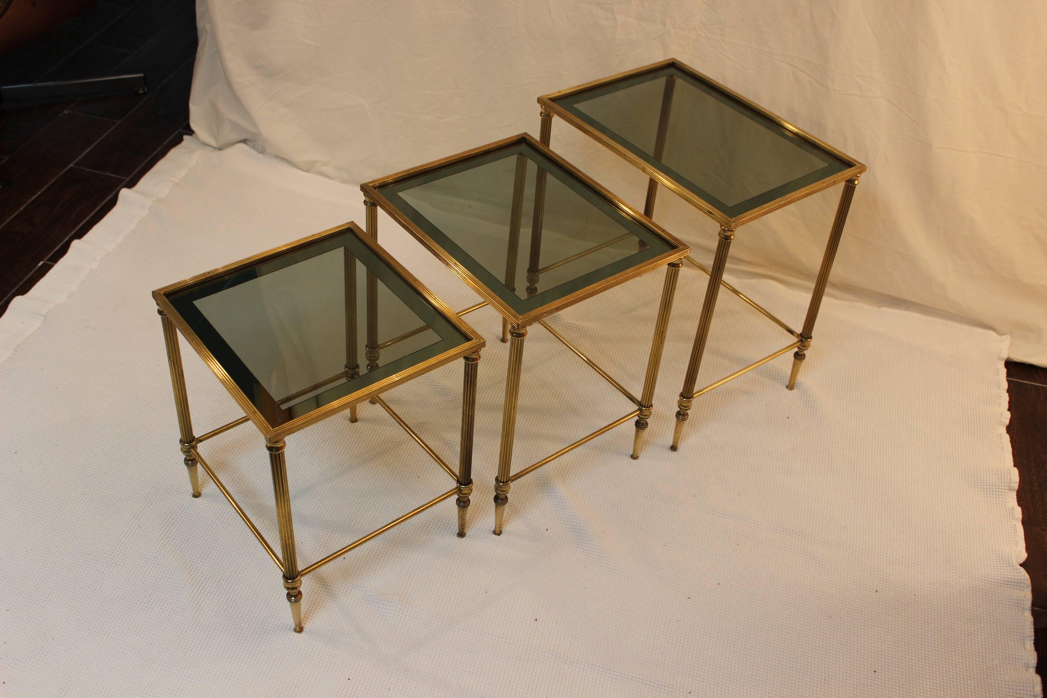1950's Italian solid brass modern nesting tables with glass tops.

tables measurements:
Large table width 19'' depth 13.5'' height 20.5''
Medium table w. 16.5'' d. 13.5'' h. 19''
Small table      w14'' d. 13.5'' h. 17.5''