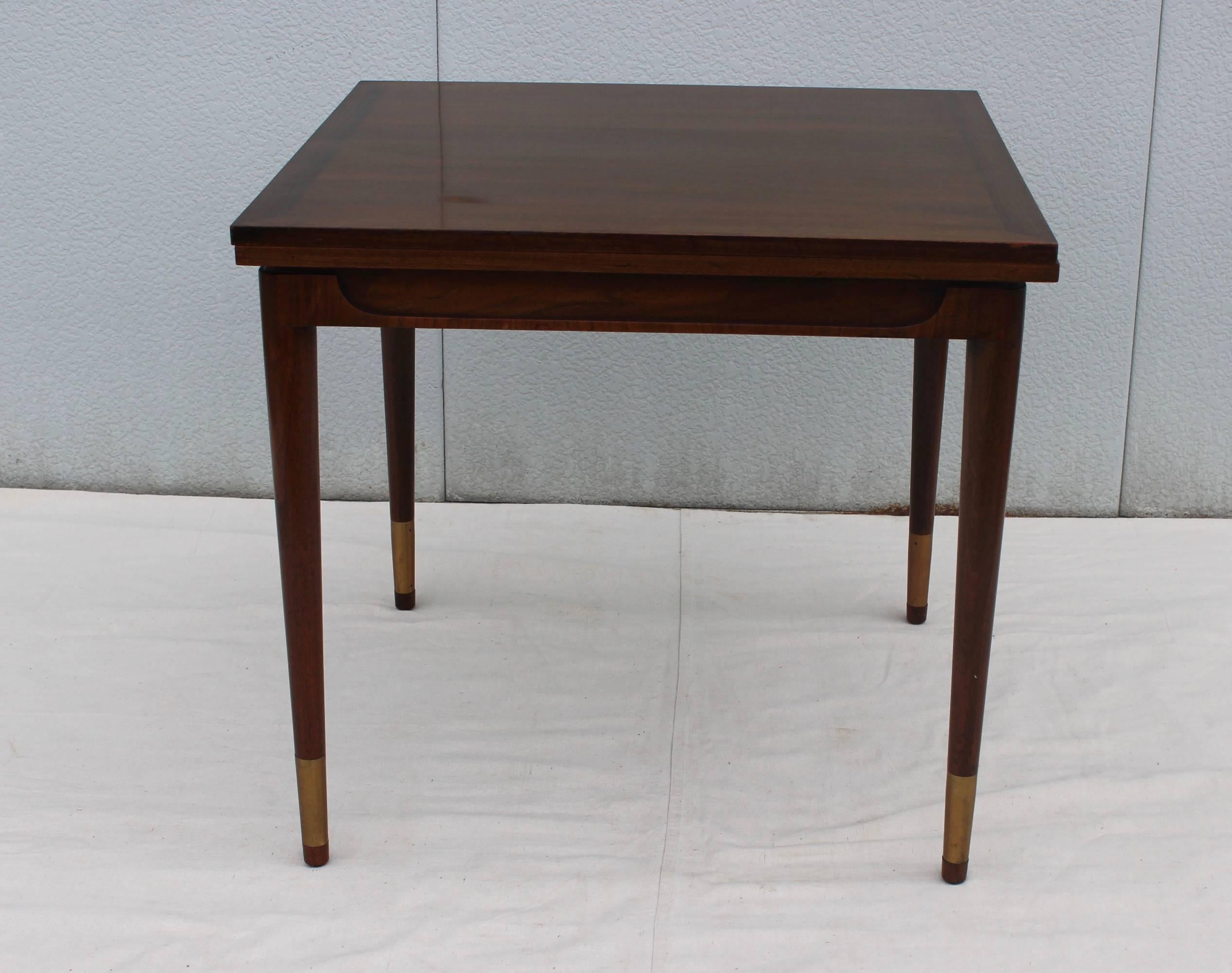 1950s Bert England design from the forward trend collection for Johnson Furniture game table. The top opens to double the size with brass sabots detail.

Table diameter 32''.
