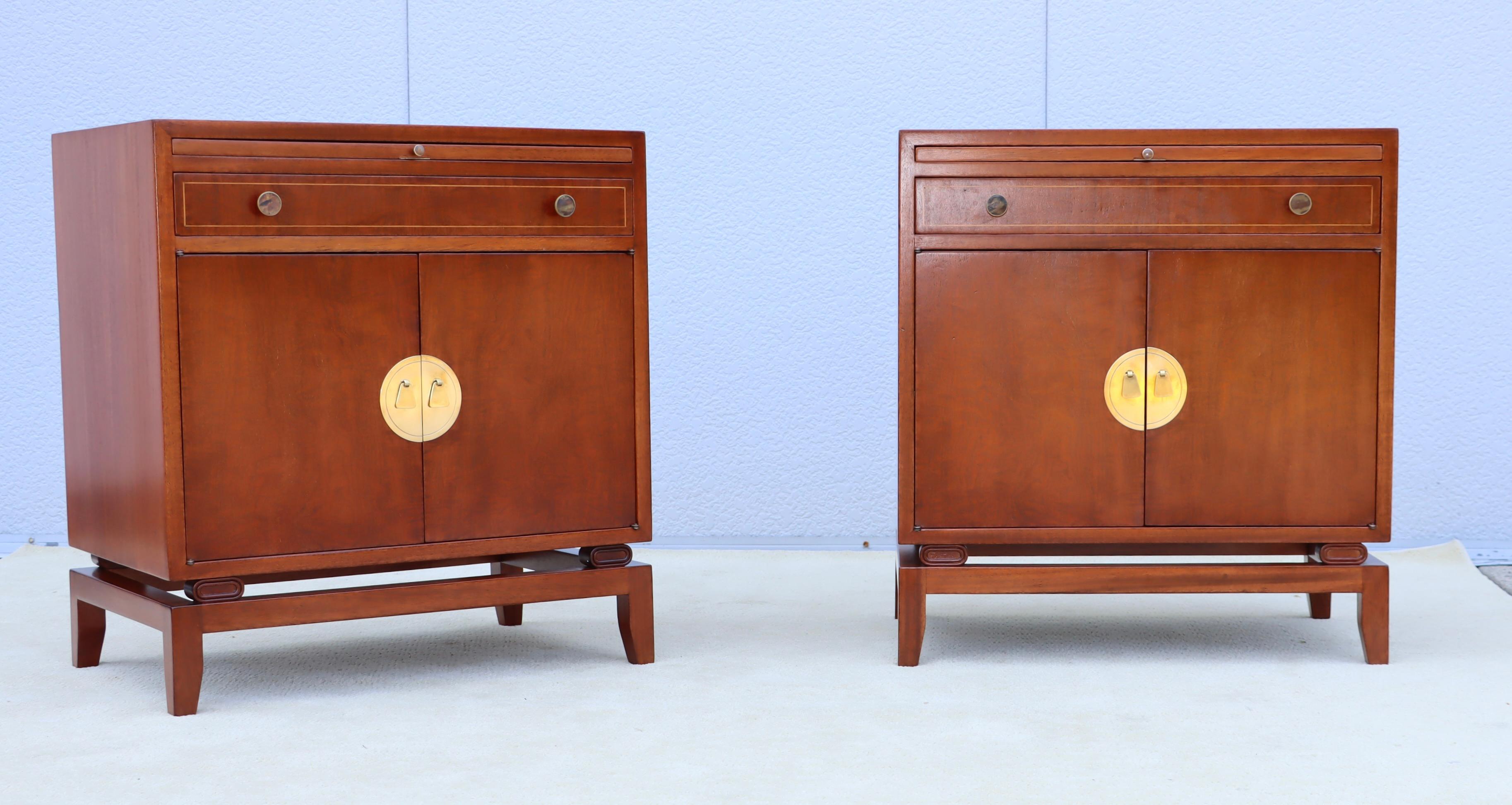 Rare pair of 1950's mahogany and brass Tommi Parzinger designed for Charak Modern night stands, with one drawer a pull out writing table and two doors with an adjustable shelf, fully restored with some wear and patina due to age and use, the brass
