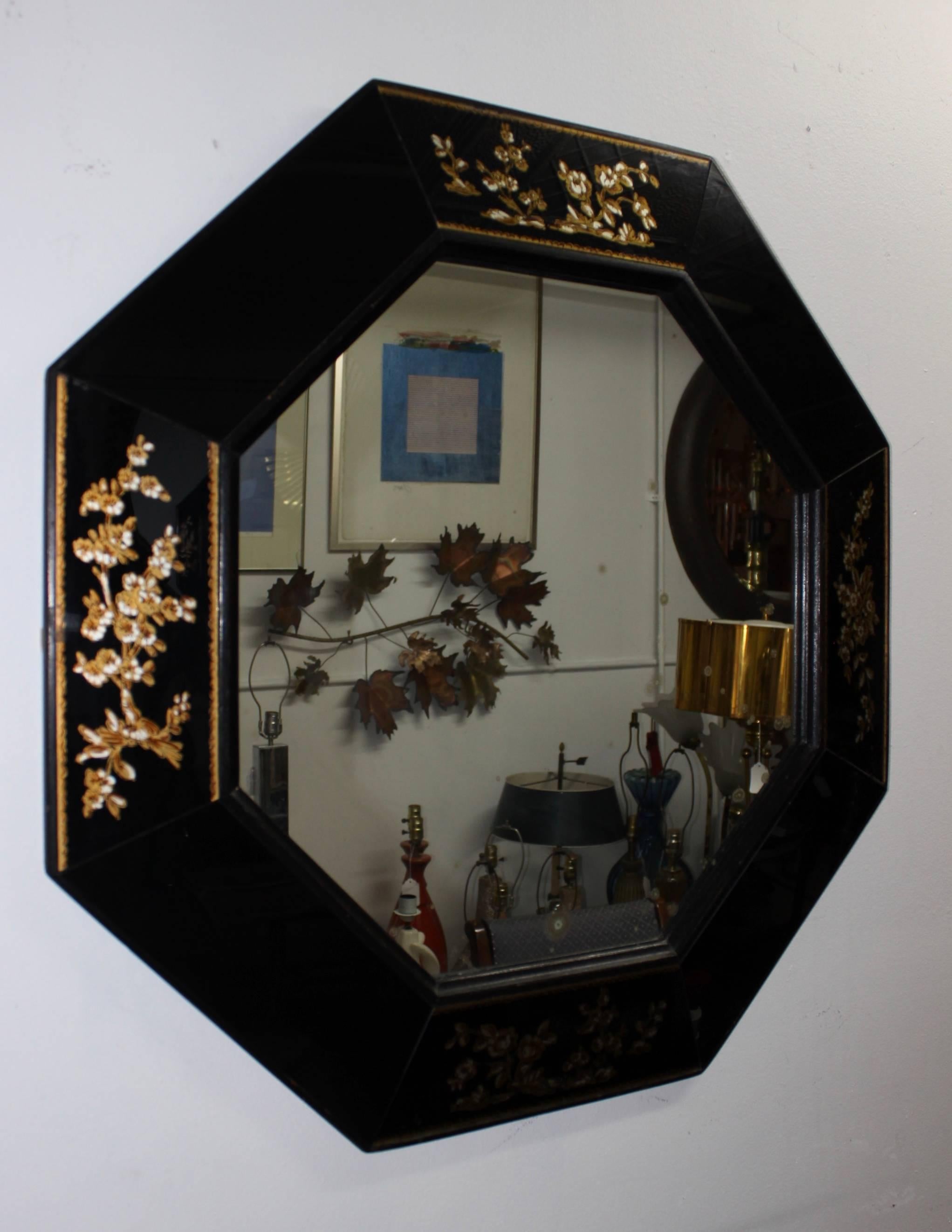 1940s elegant octagonal mirror with églomisé flower detail and wood frame.