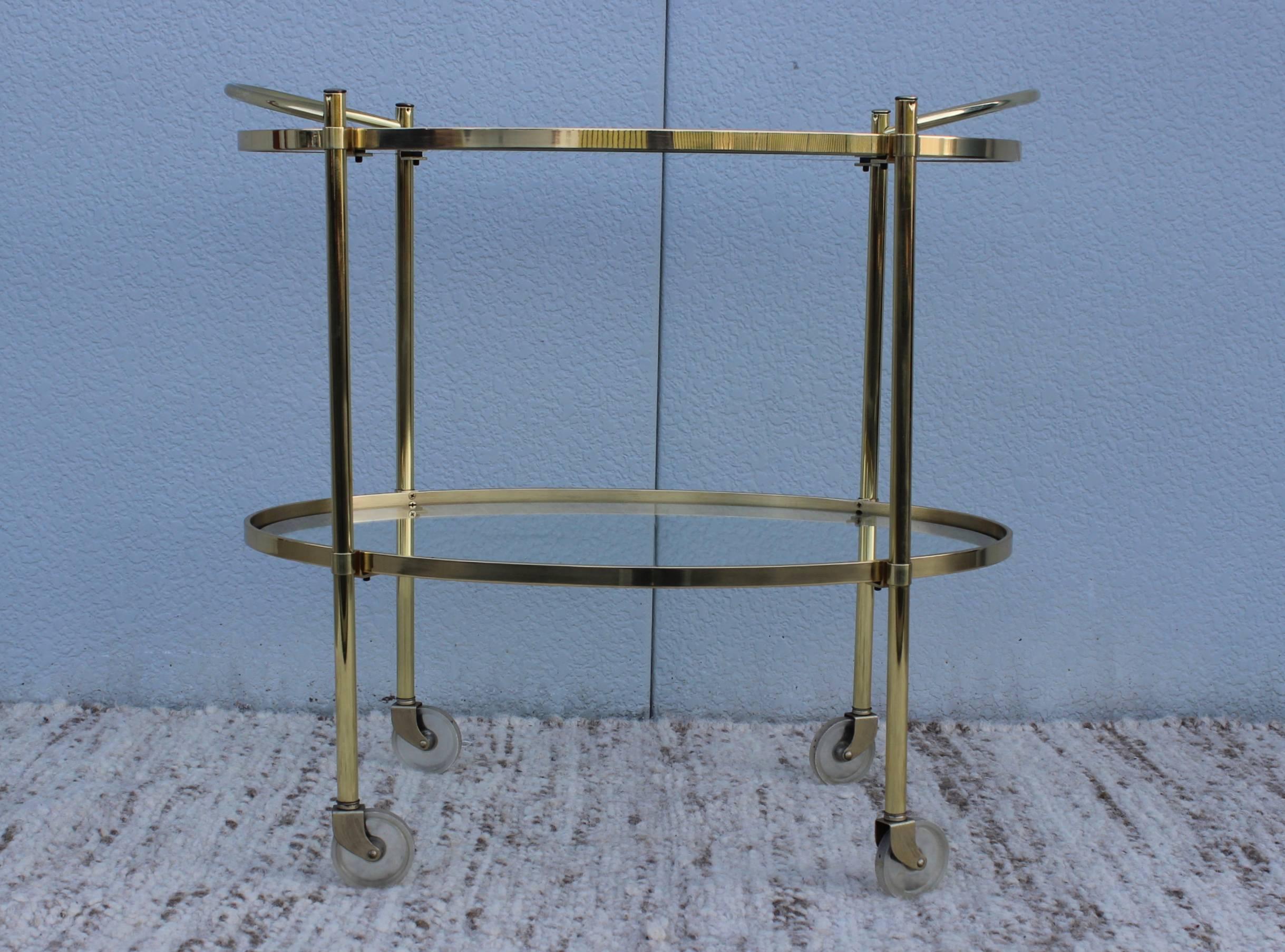 1950s solid brass two-tiered brass and glass oval Italian bar cart.