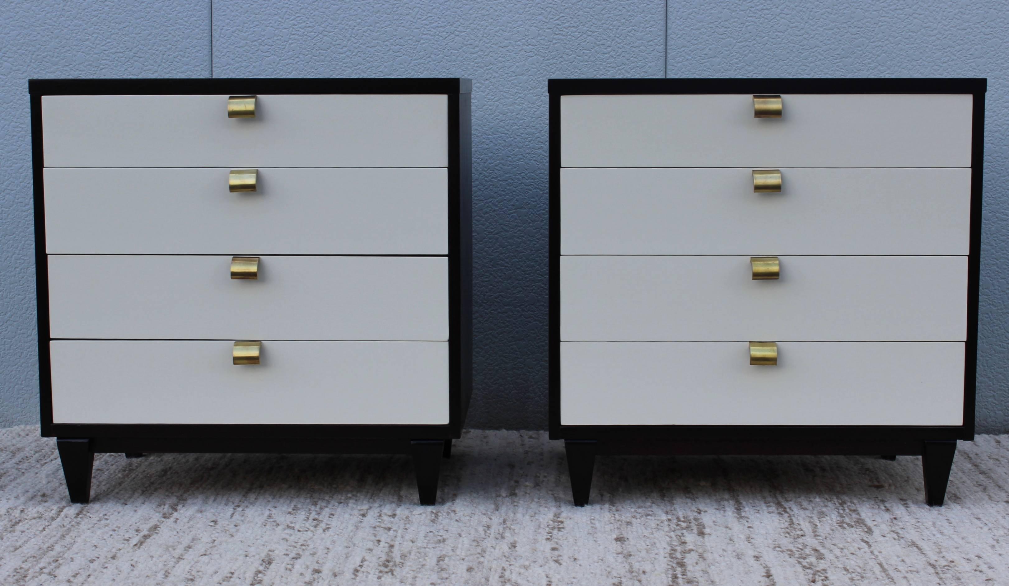 Stunning pair of 1950s Merton Gershun for American of Martinsville four-drawer bachelor chest, newly refinished in dark brown mahogany with white lacquered front and brass handles.