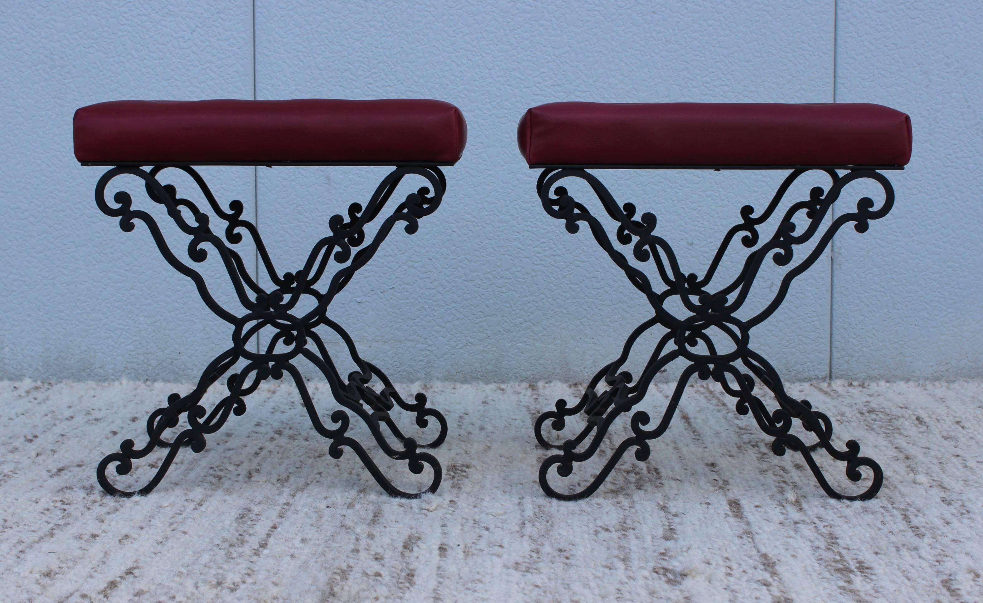 1960s iron base ottomans, newly reupholstered in leather with tufted detail.