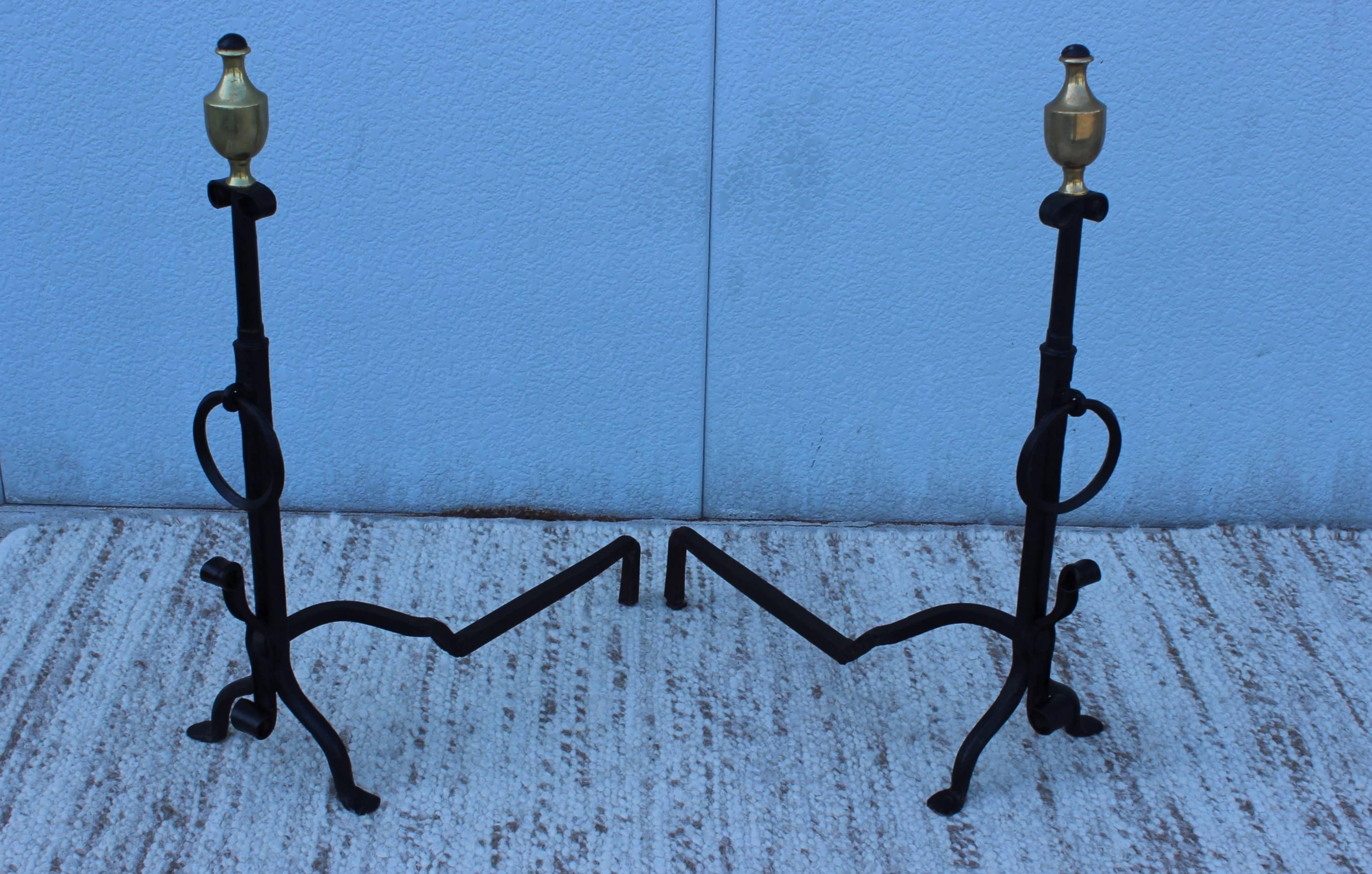 Stunning pair of large 1920s forge iron with bronze detail and decorative ring andirons.