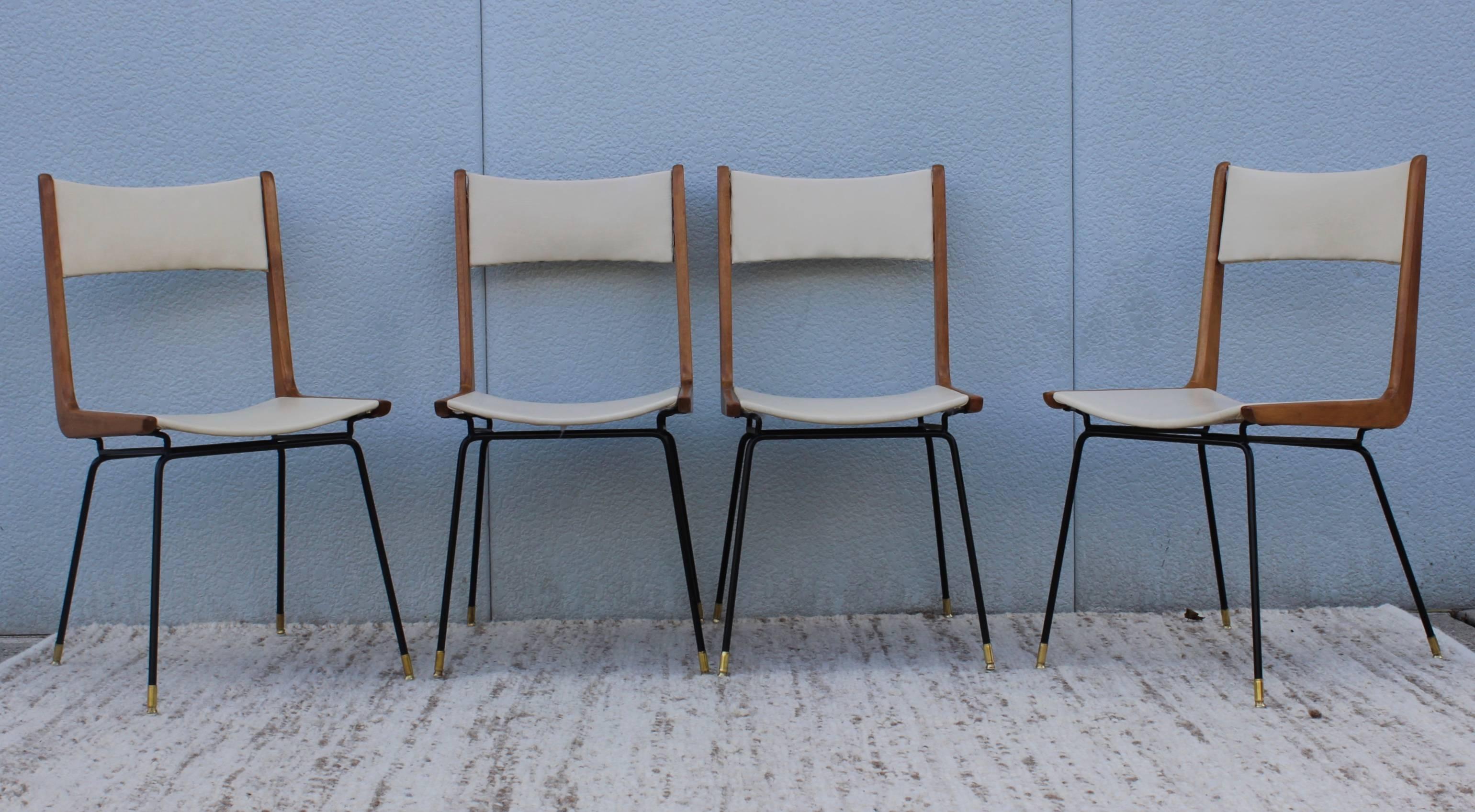 Italian dining chairs in the style of Carlo di Carli, iron frame with brass feet naugahyde upholstery, ca. 1958