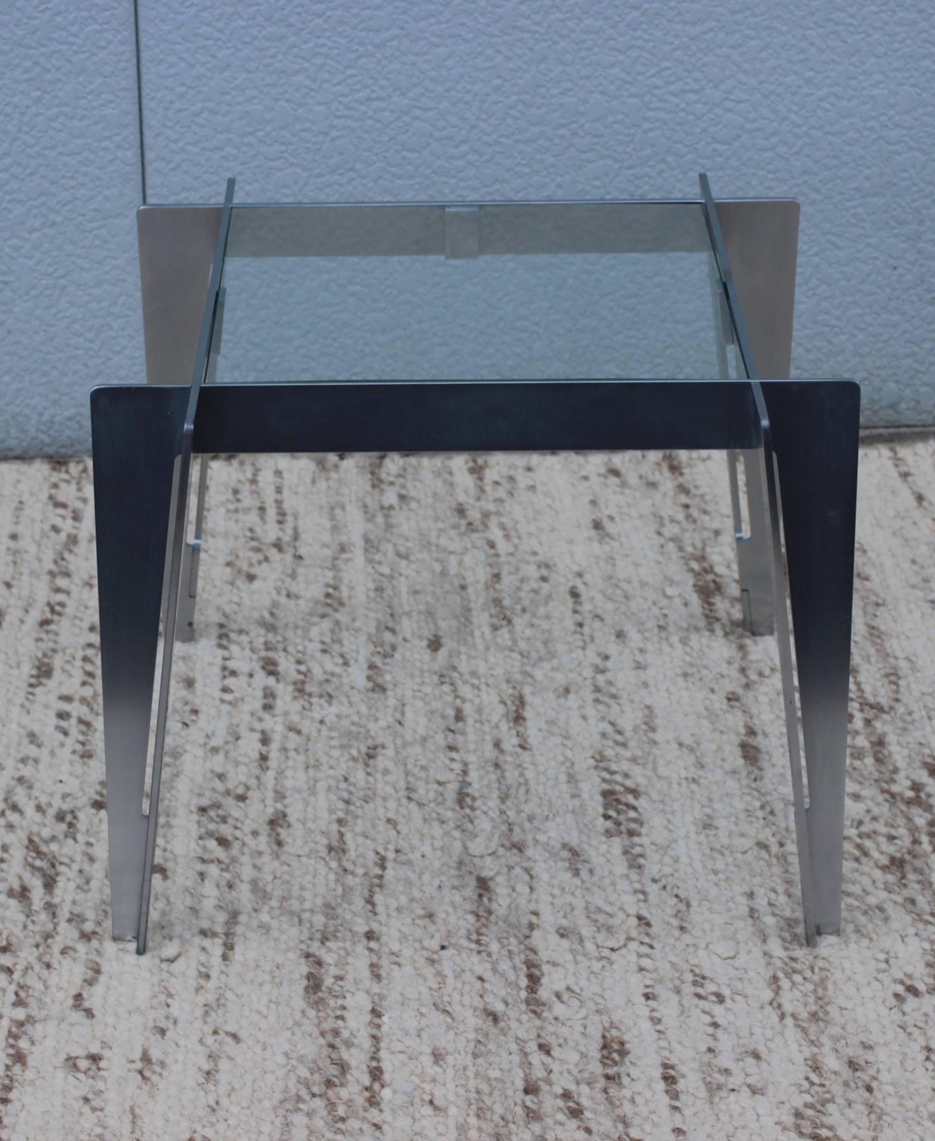1970s brushed steel interlocking side table with glass top.