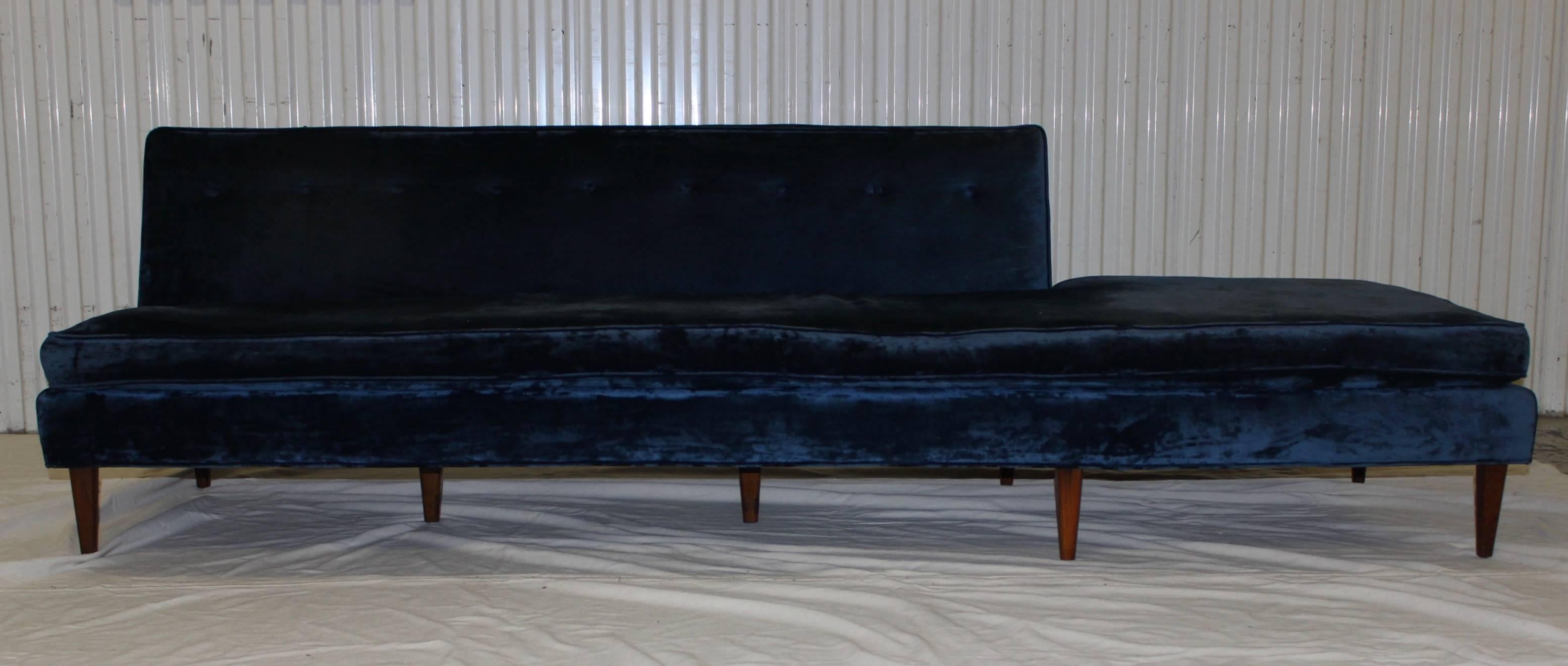 Stunning 1960s long armless modern sofa, in vintage velvet upholstery with solid walnut legs.

It needs new upholstery.