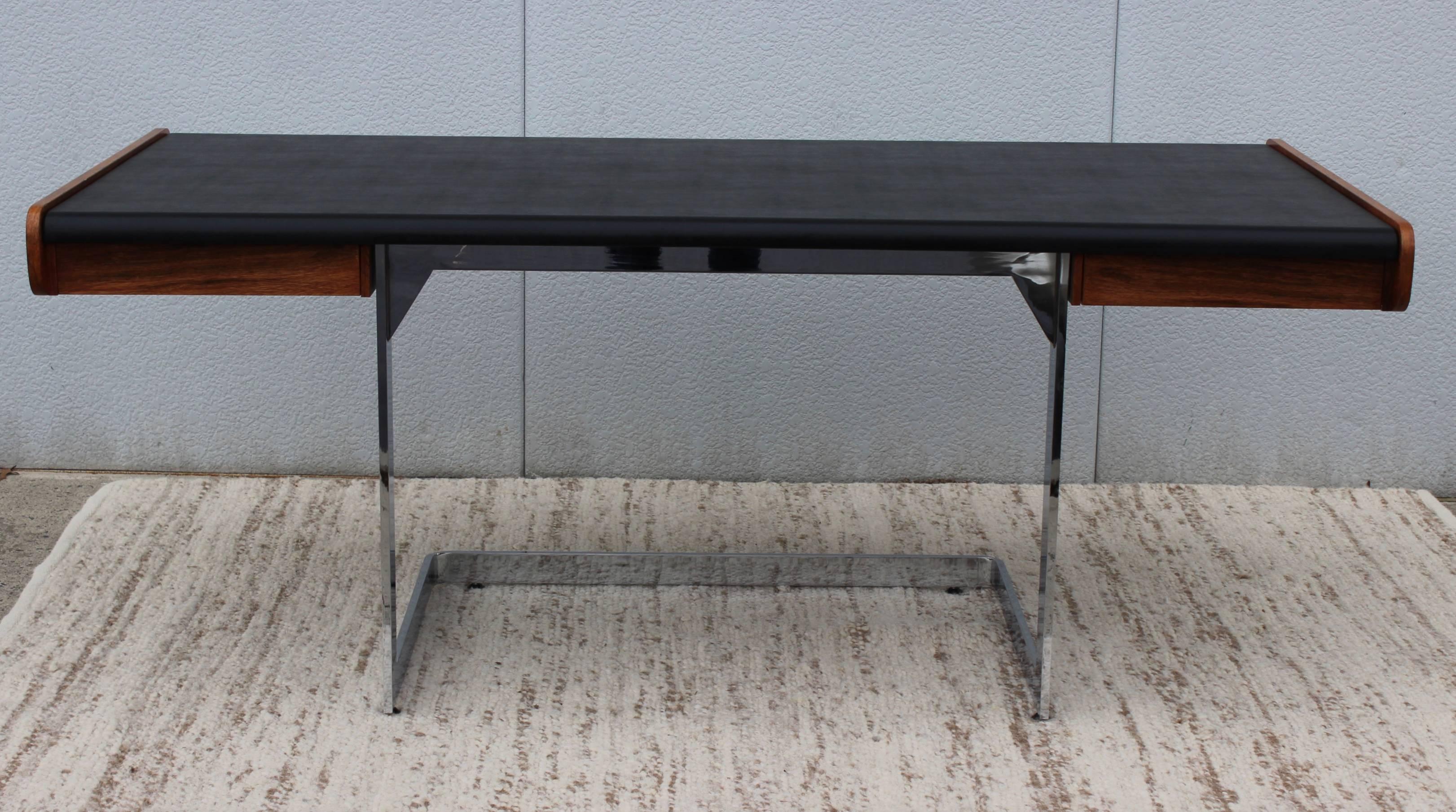 Stunning 1960s Ste Marie & Laurent modernist desk, with sleek heavy steel cantilevered chrome base and rosewood and Naugahyde writing surface, with two drawers.