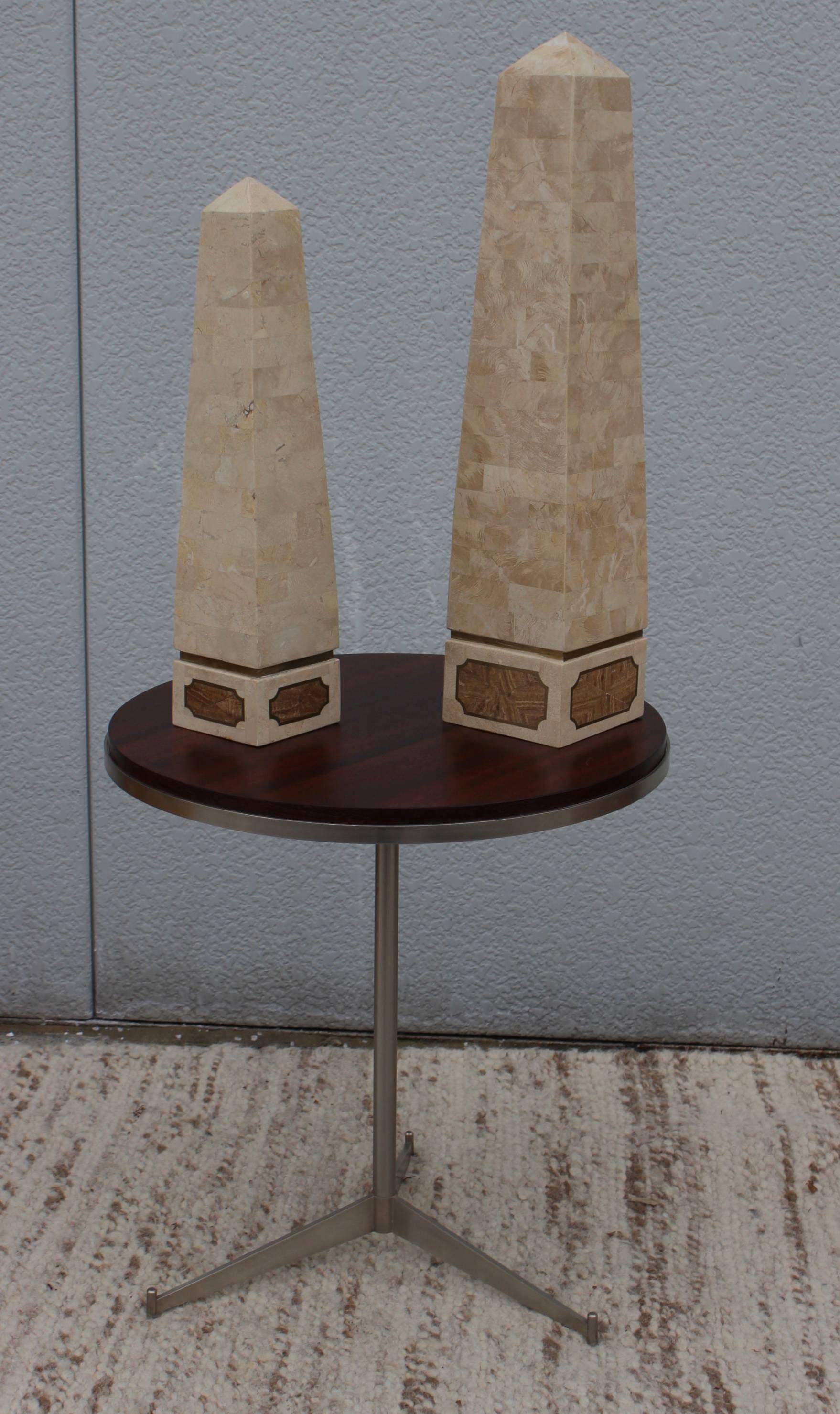 1970s modern Maitland Smith Style tessellated stone with brass inlay detail obelisks, in vintage original condition with minor wear and pagtina due to age and use.

Smaller obelisk height 19.25'' diameter 4.25''.