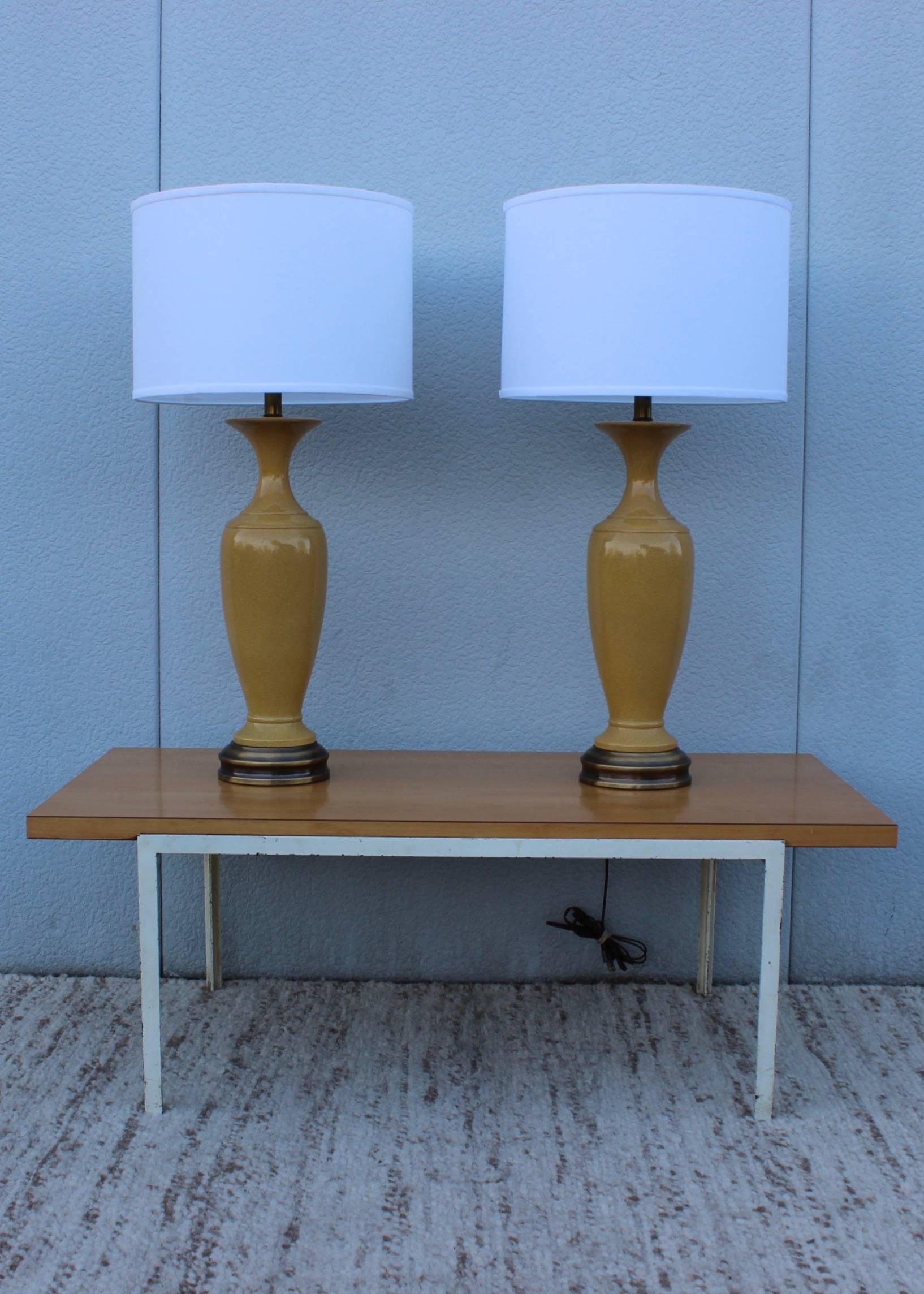 1960s crackled ceramic table lamps with brass hardware.

Shades for photography only

Measures: Height to light socket 25''.