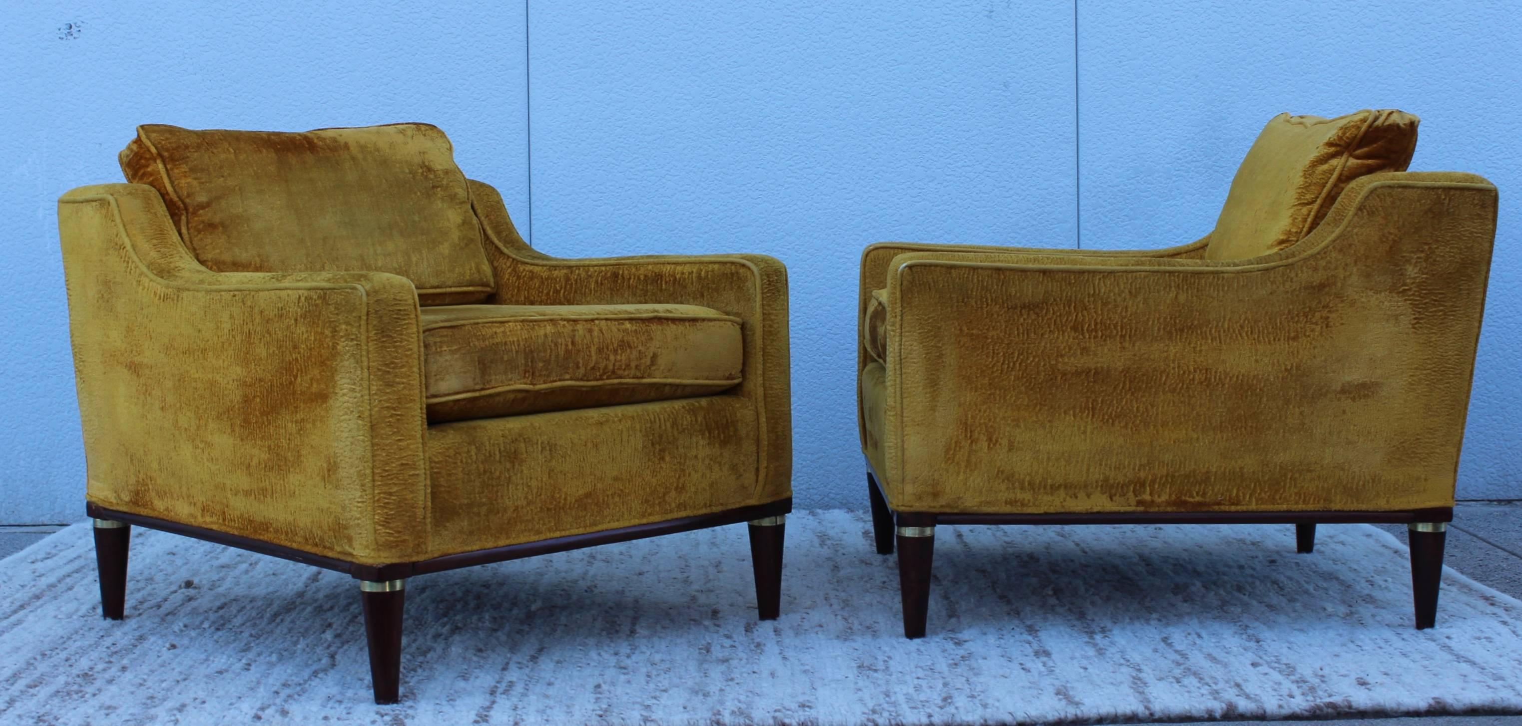 Stunning pair of 1950s low back lounge chairs with wood base and brass ring detail, in vintage original upholstery. 

They need new upholstery.