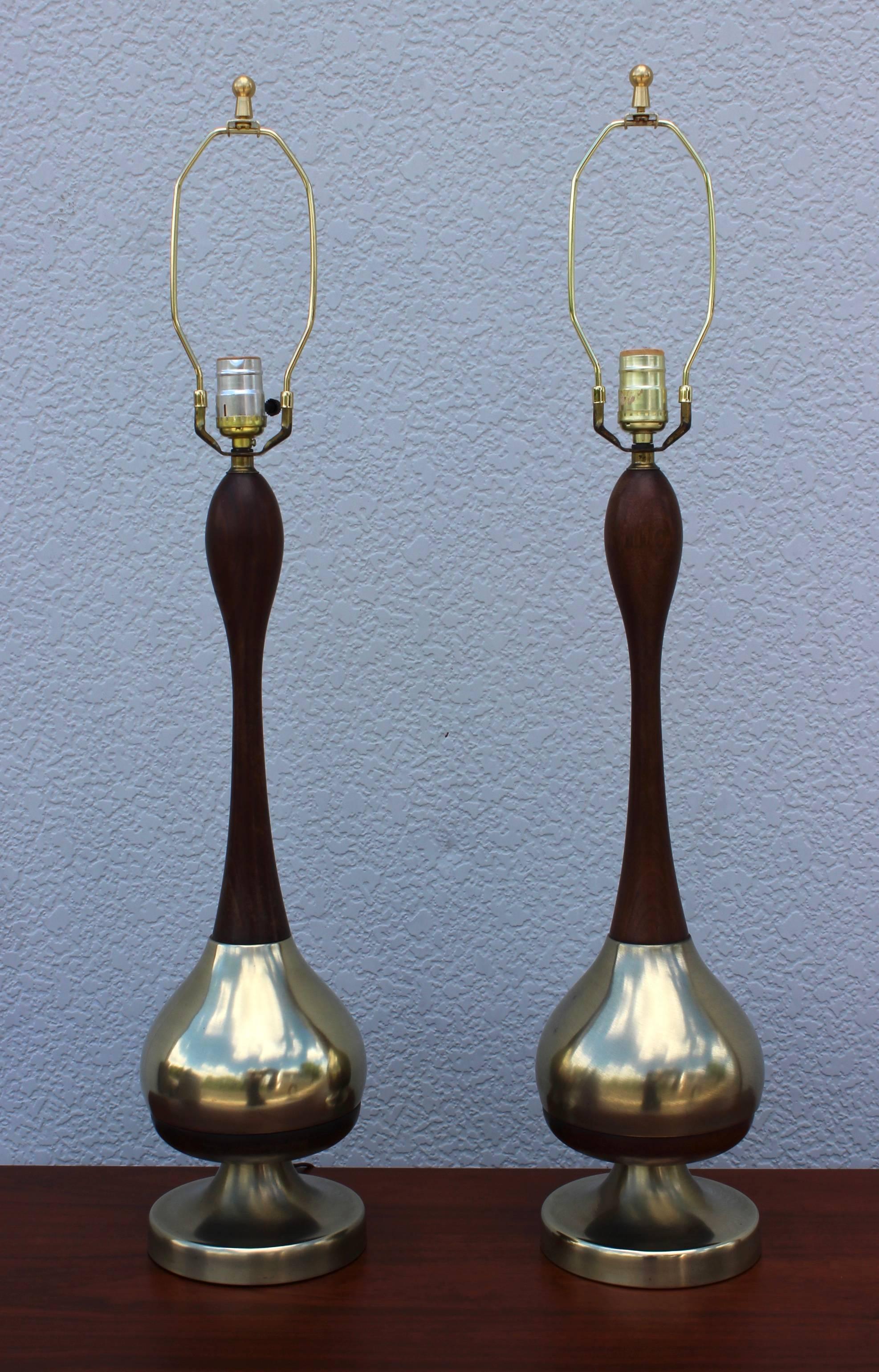 1950s Tony Paul brass and walnut table lamps. 

Measures: Height to light socket 25