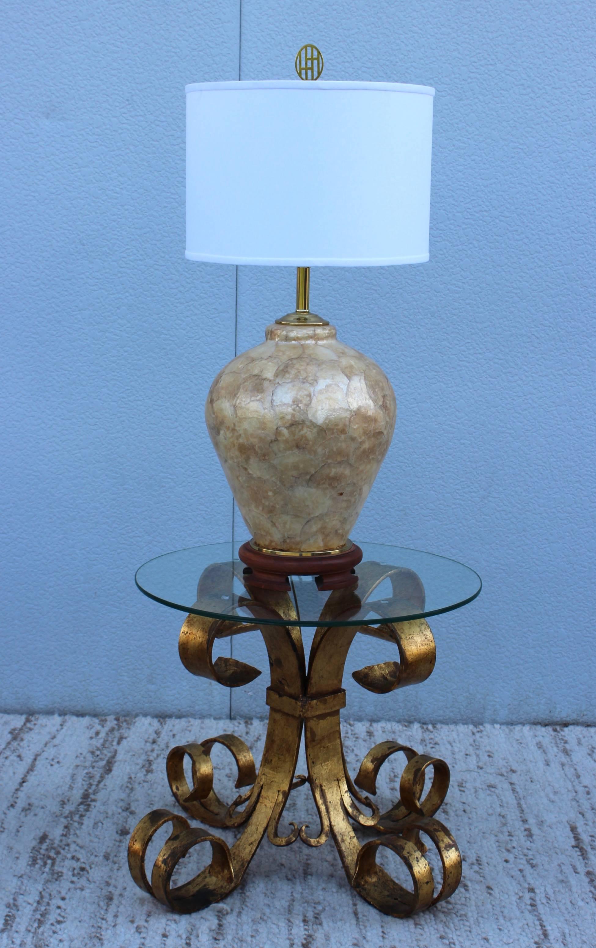 Large 1970s Capiz shell table lamp, with teak base and brass hardware.

Shade for photography only.

Measure: Height to light socket 24''.