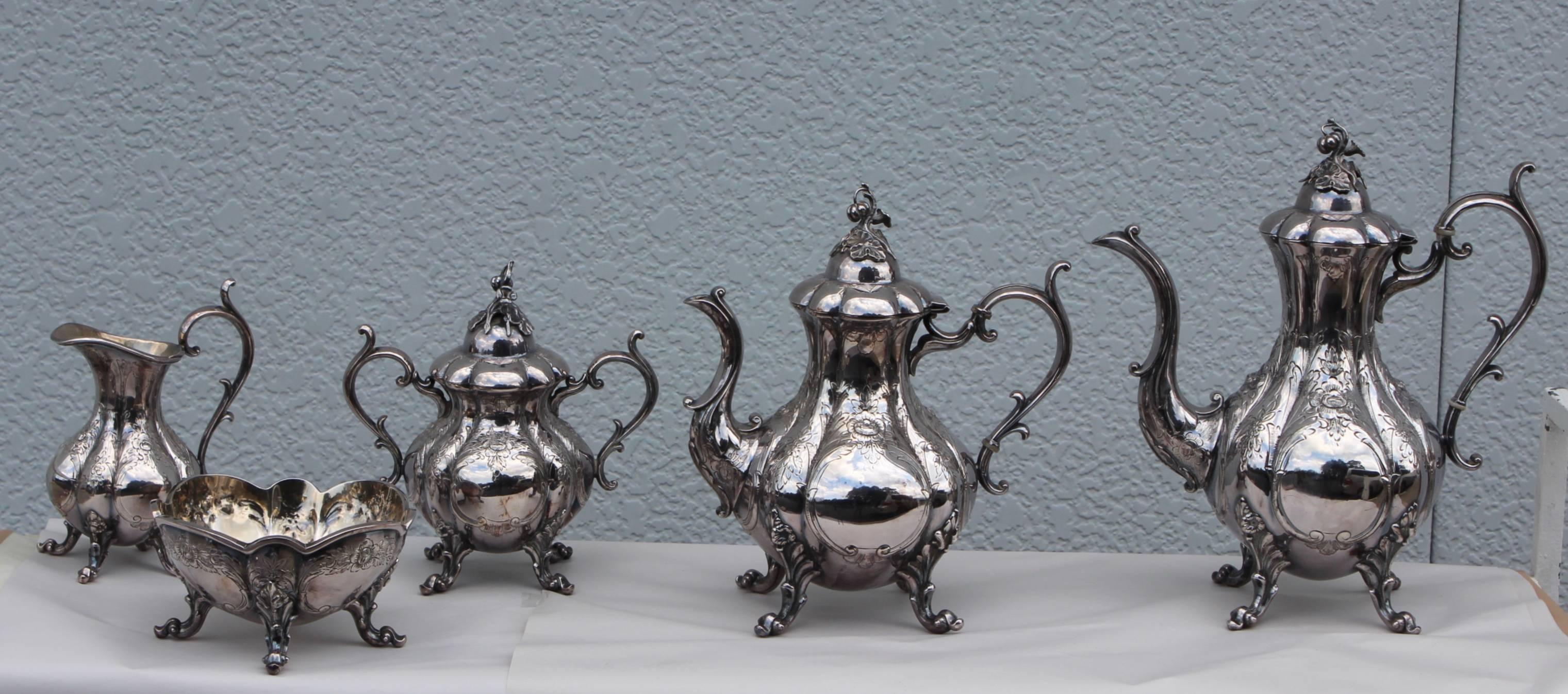 1940s Reed & Barton hand chased tea set.

Set includes:
Large coffee pot height 12'' depth 6'' width 11''
Tea pot height 10.5'' depth 6.5'' width 9.5''
Creamer height 7.25'' depth 4'' width 5.5''
 Sugar covered bowl height 8'' width 8'' depth
