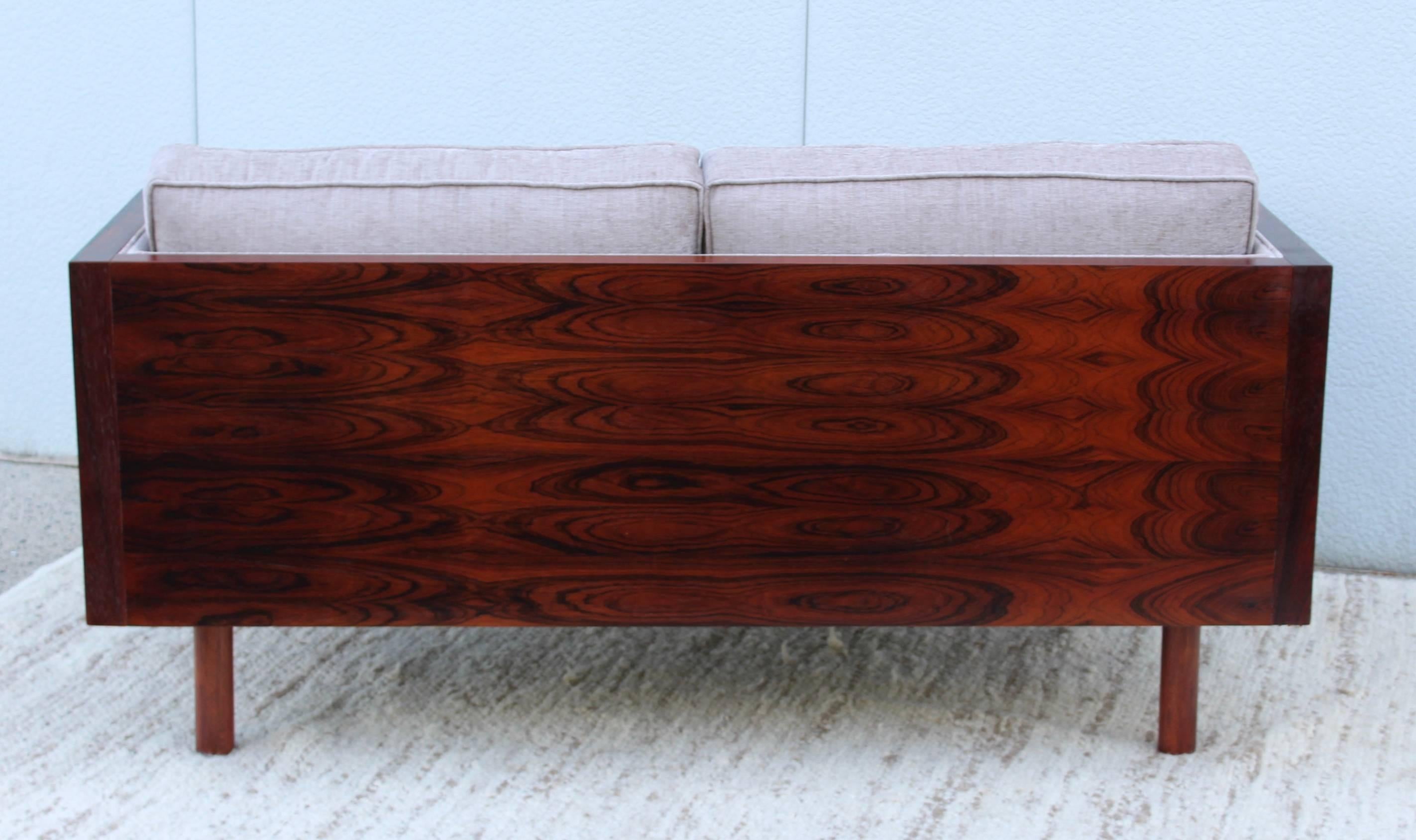Stunning 1960s rosewood case loveseat in the style of Milo Baughman. Made in Israel newly upholstered.