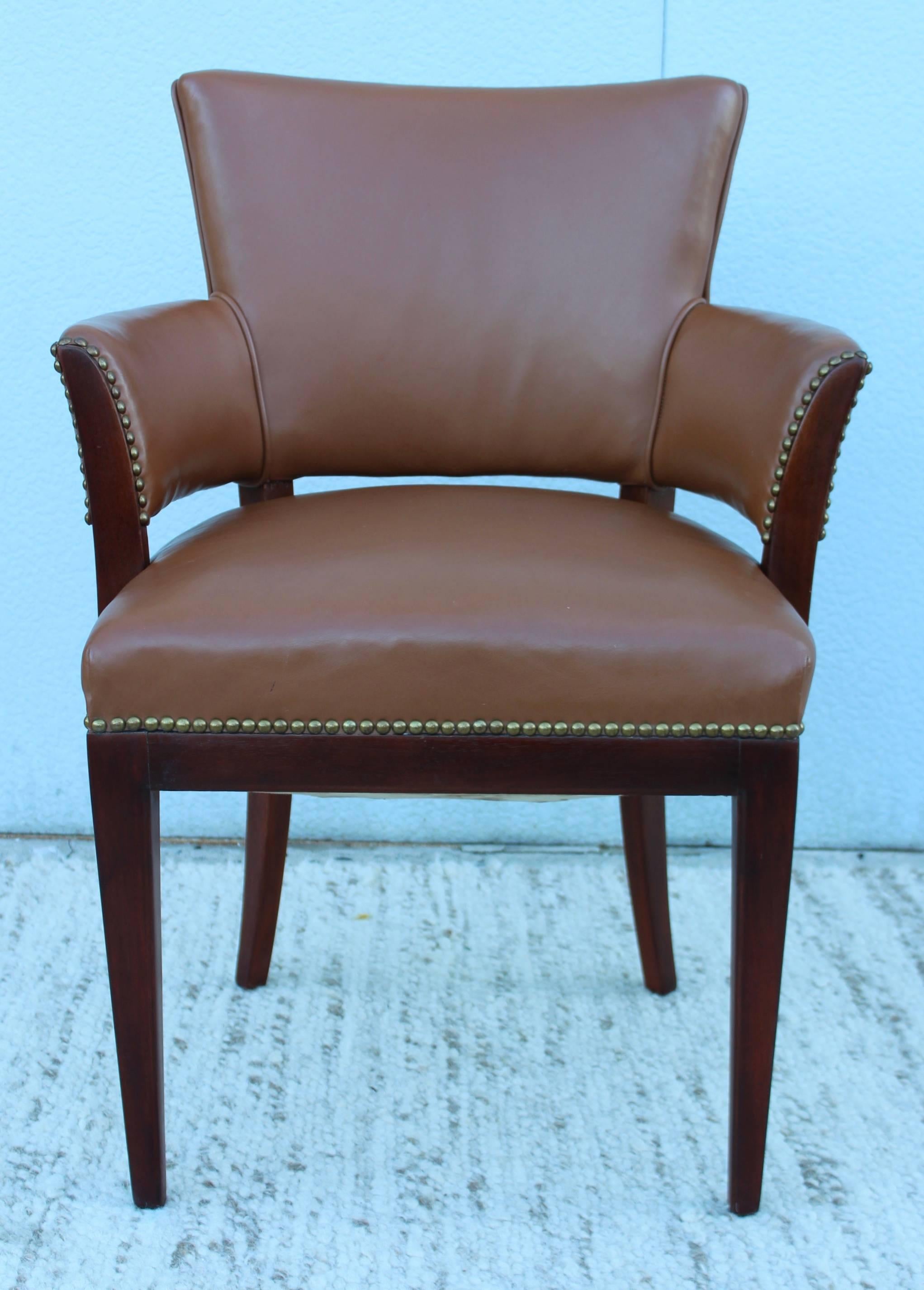 1960s modern walnut and leather armchair with brass nailhead detail.