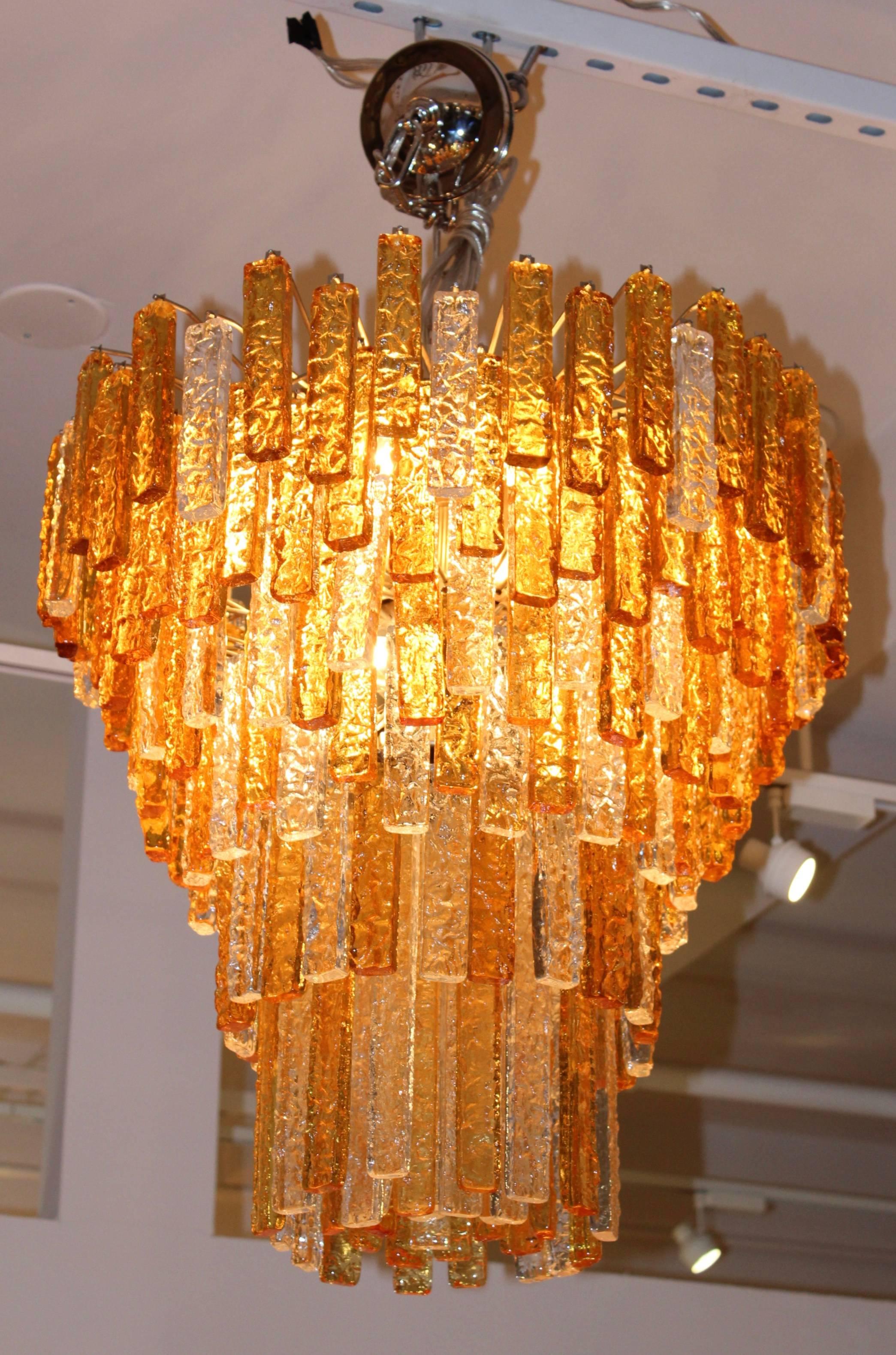 Stunning large 1960s Venini clear and amber glass chandelier. Newly professionally rewired and ready to use.

Frame and glass height 24.5''

The chain height can be adjusted.