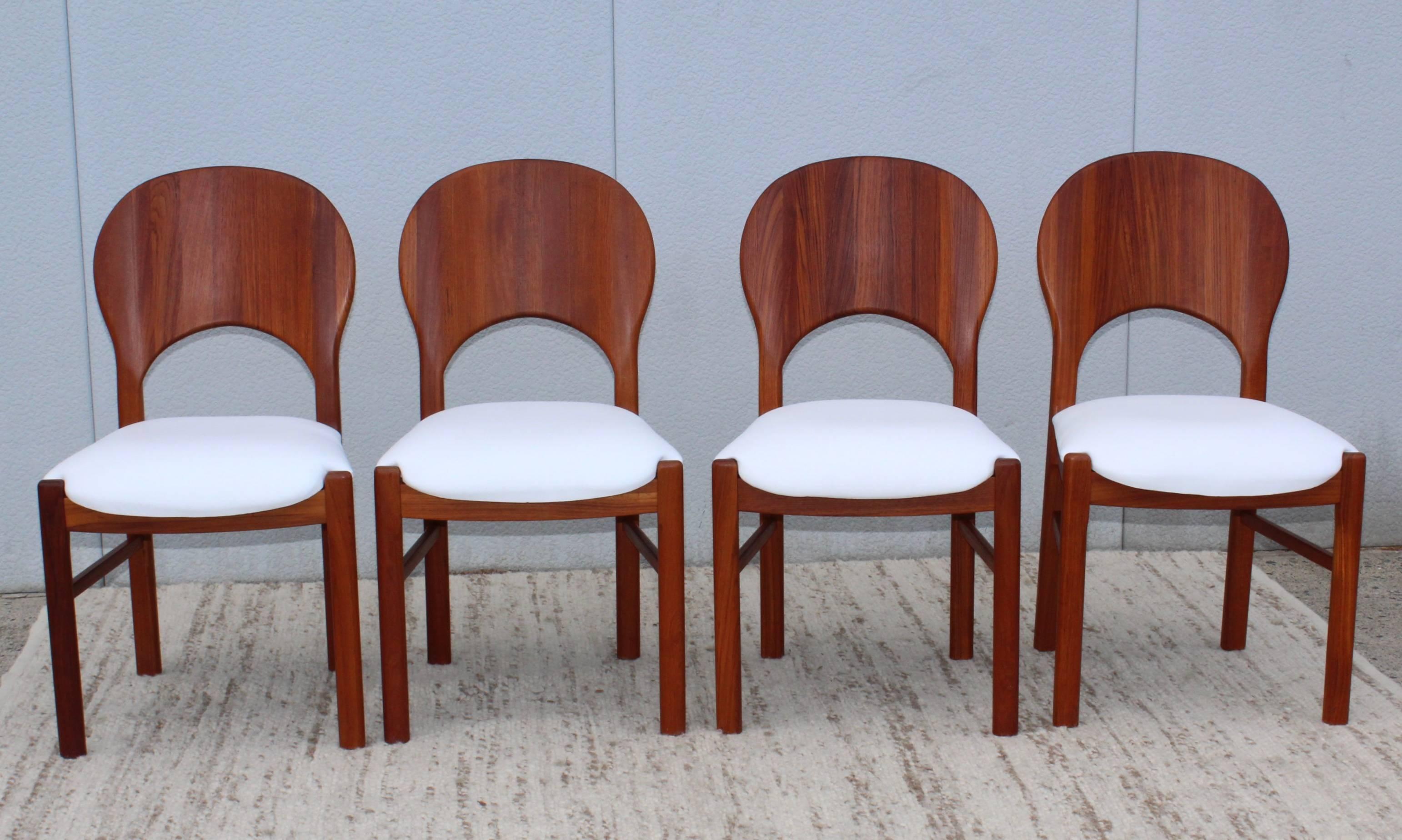 Rare set of four sculpted teak with white leather upholstery dining chairs by Benny Linden.