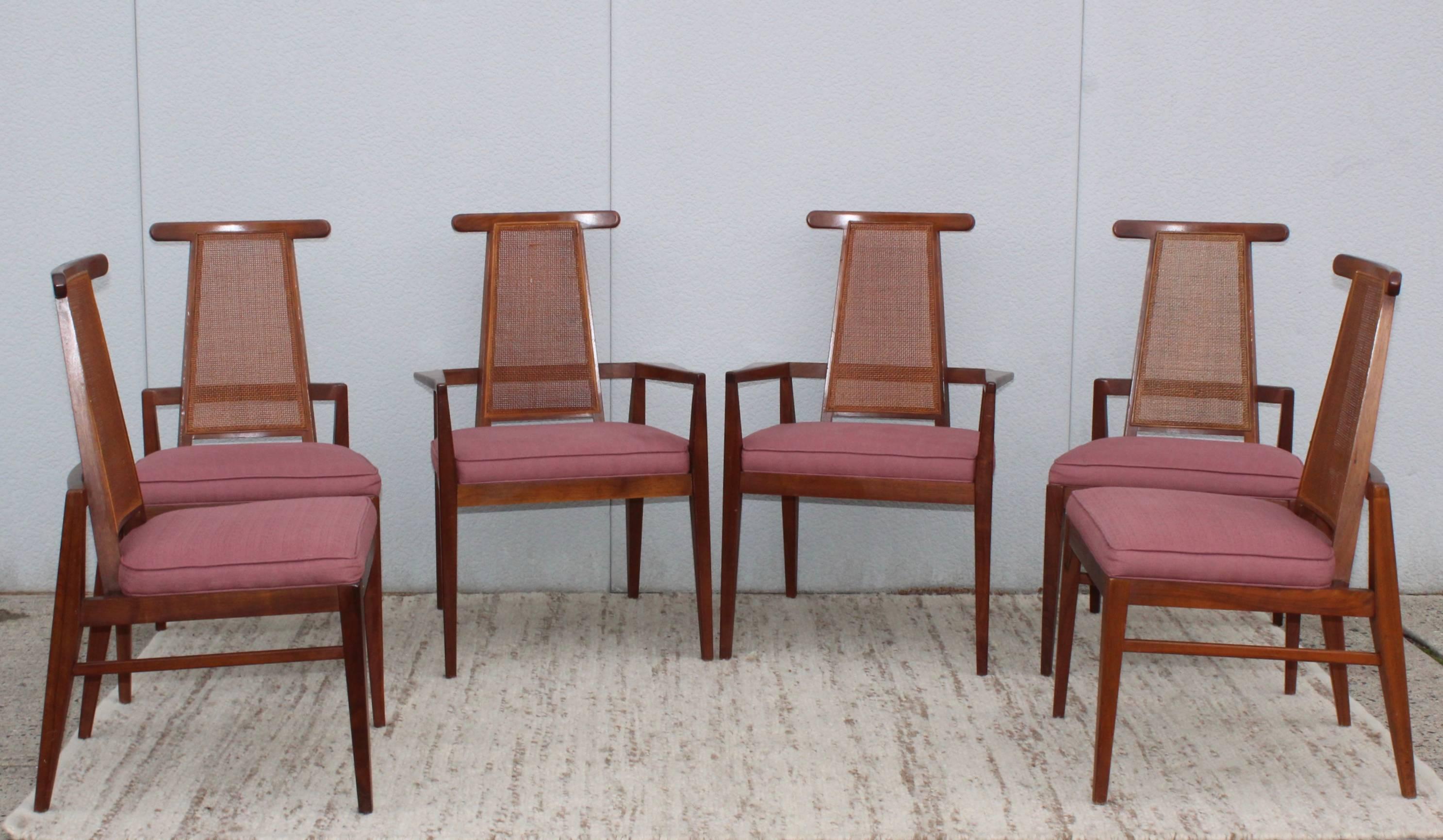 Stunning set of six Foster McDavid walnut dining chairs. Two armchairs and four side chairs with vintage upholstery and cane backs.
