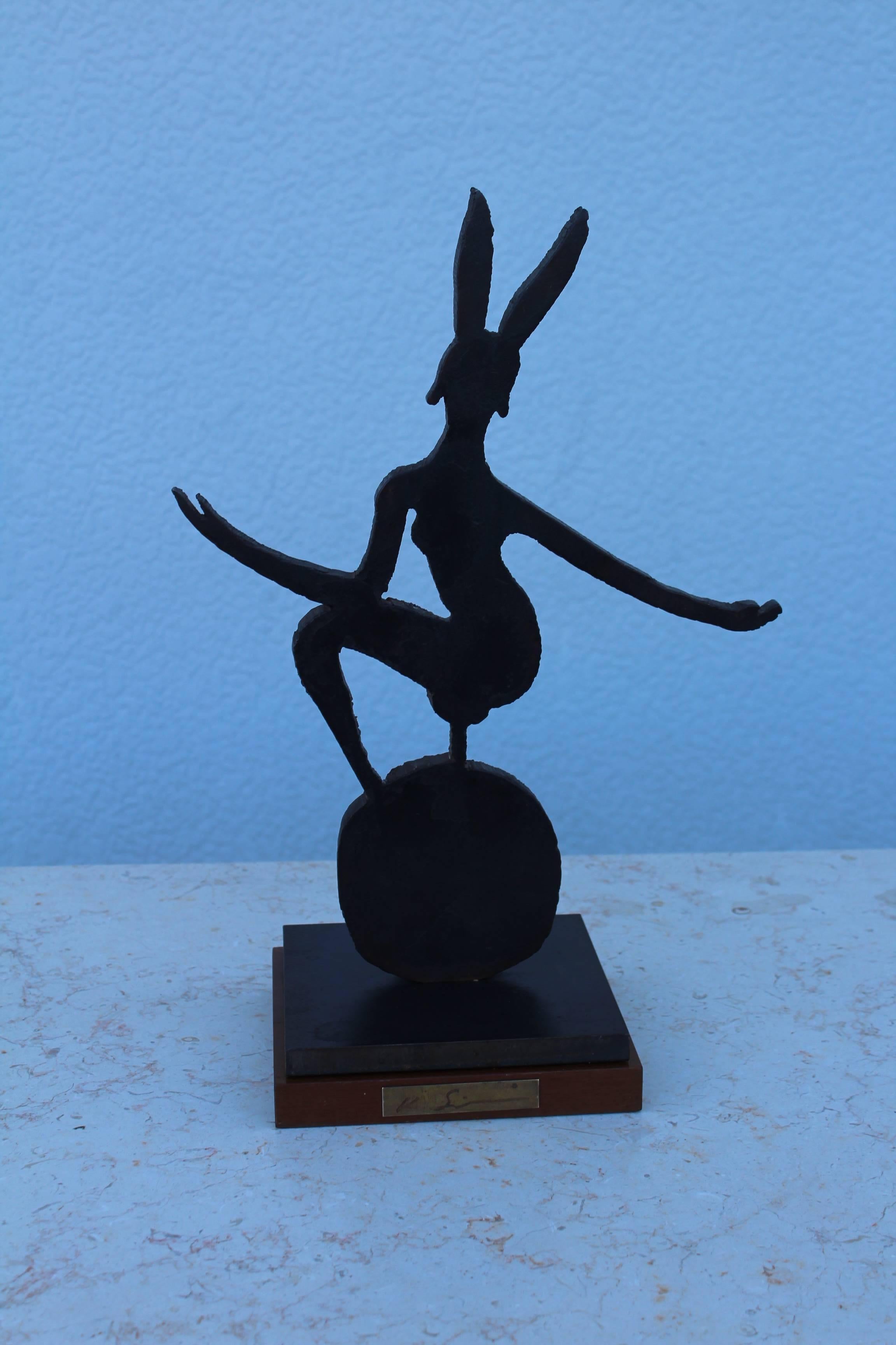 1970s signed steel playboy sculpture with wood base.