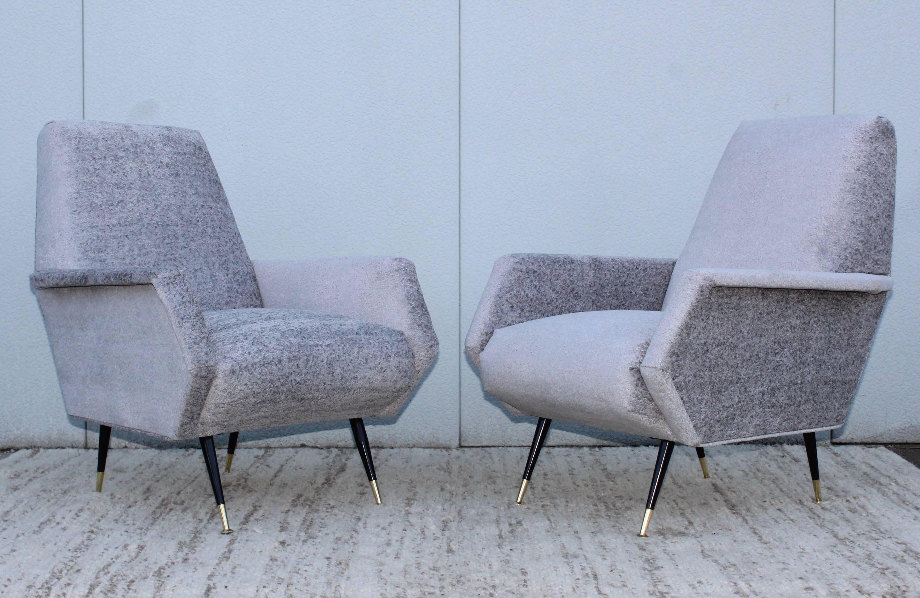 Stunning pair of 1950s modern Italian lounge chairs newly restore and reupholstered.