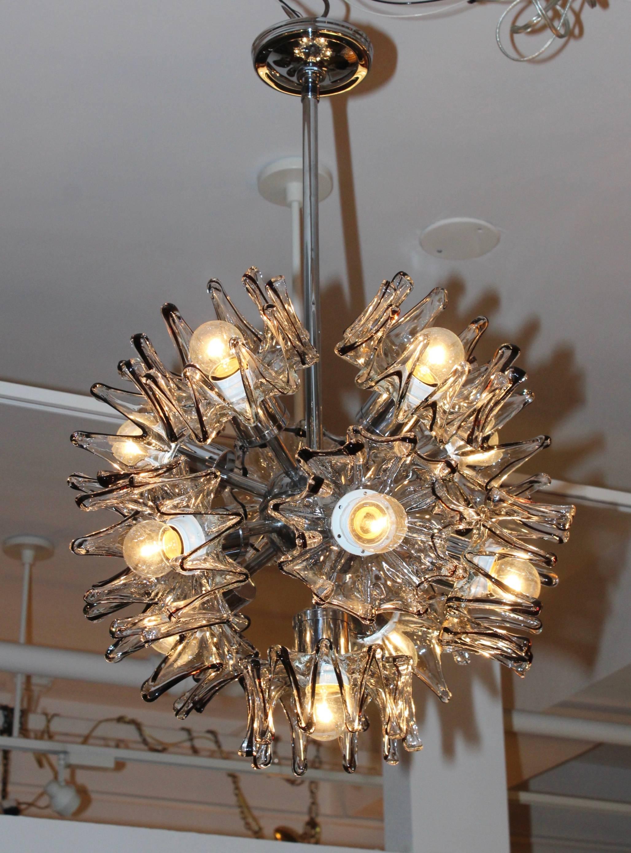 1970s Mazzega 11 lights chandelier, chrome frame with black and clear sculptural glass shades.