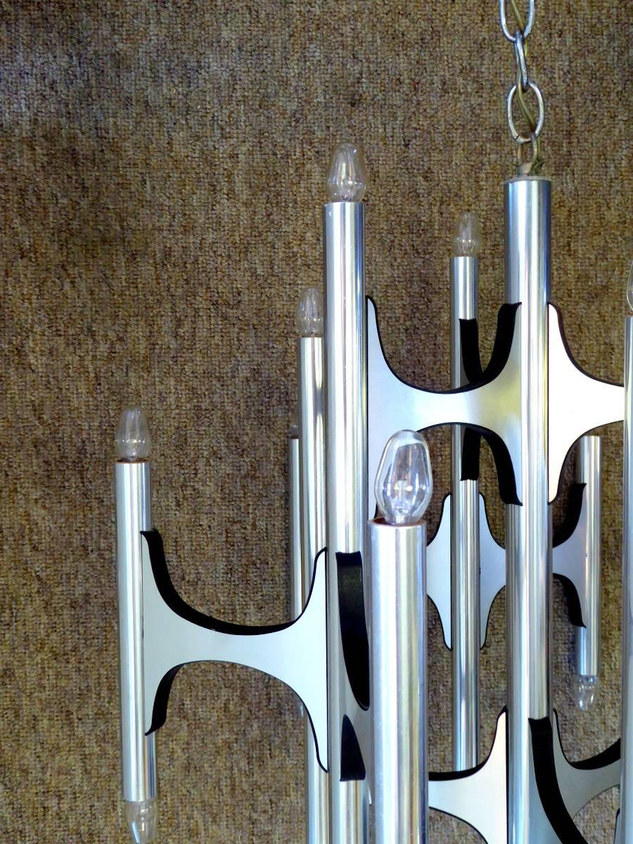 An exquisite twenty-four-light brushed aluminum chandelier by Gaetano Sciolari for Lightolier. Features Sciolari's distinctive positioning of lights facing both up and down.

A few important notes about all items available through this 1stdibs