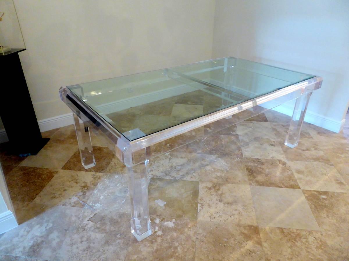 A massive, sparkling Lucite dining table with 4