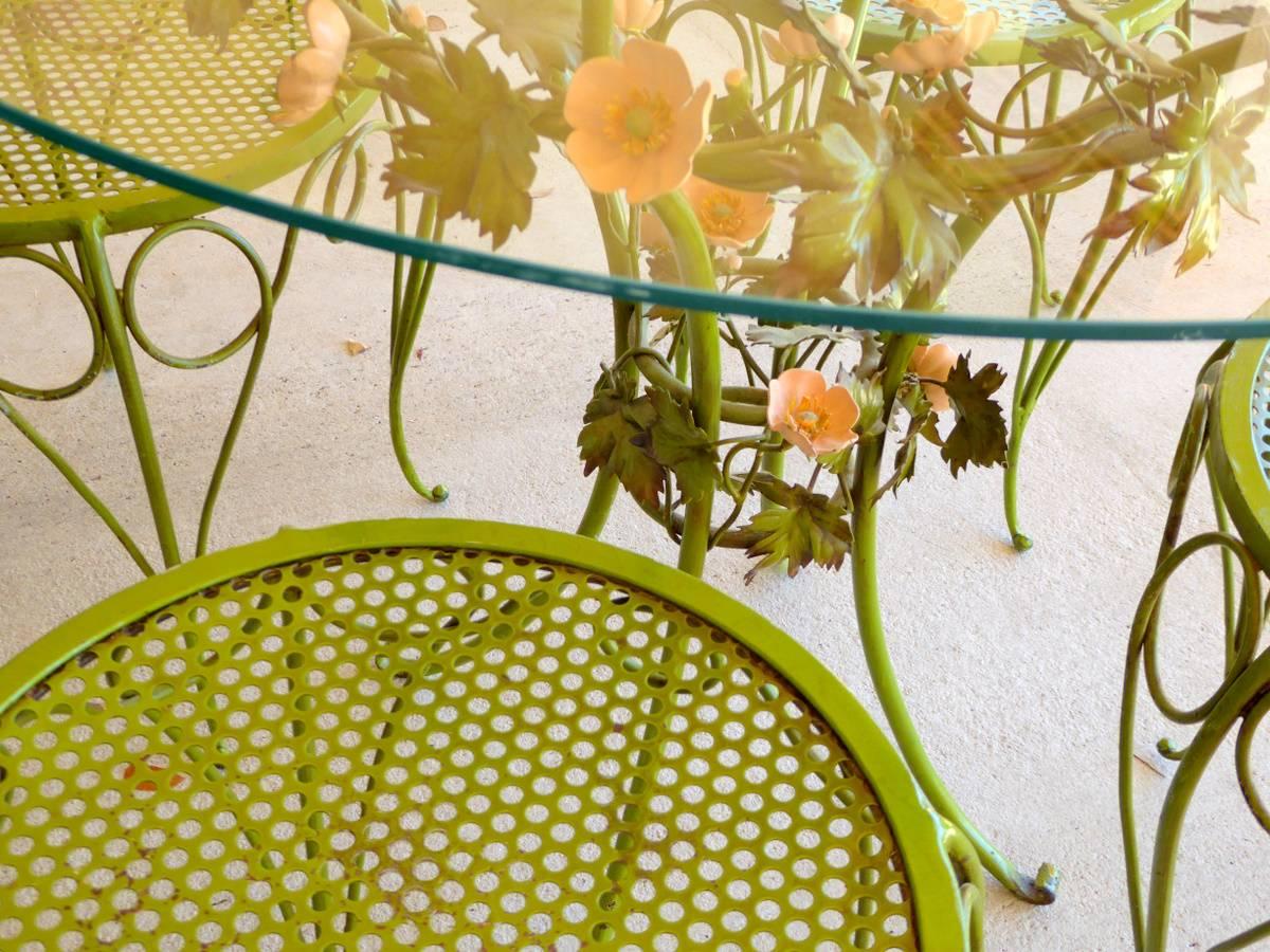 The world's most adorable patio set. Lacquered or enameled wrought iron (also known as tole or toleware) in the form of vines and flowers. Most likely made in Italy. Includes table and four chairs.

Dimensions shown are for the chairs. The table is