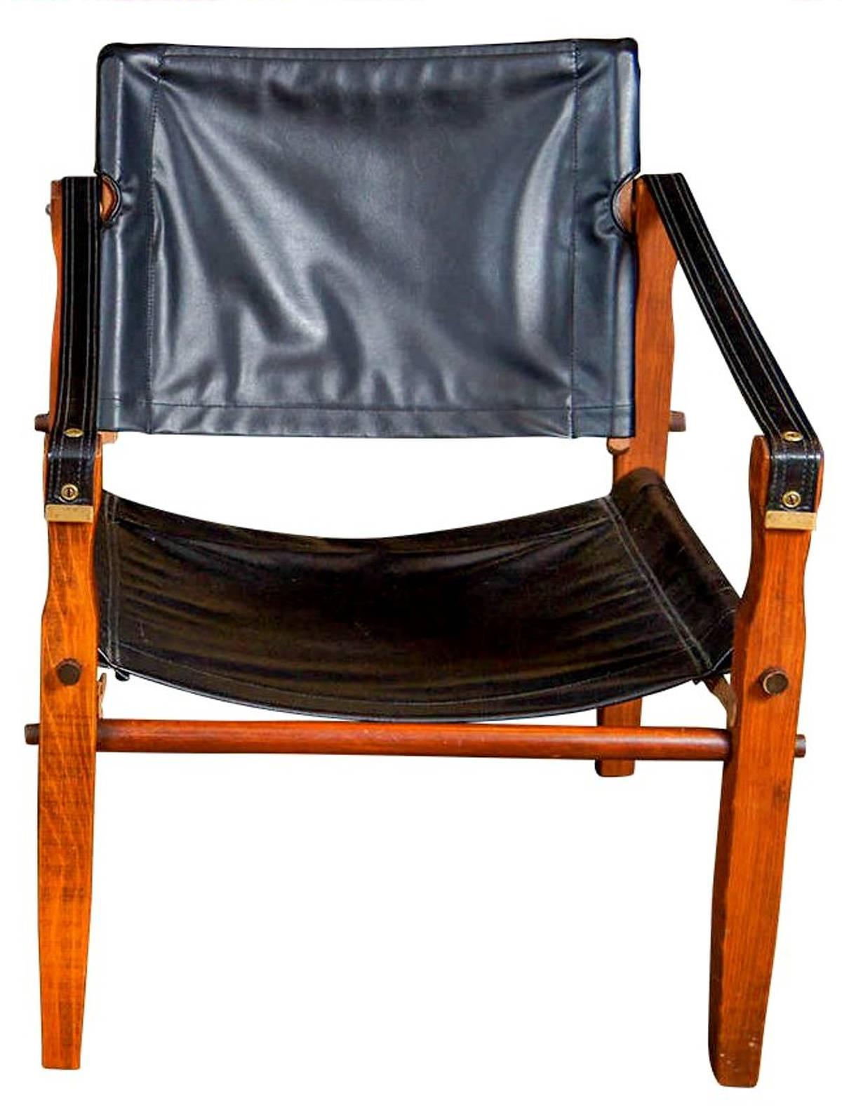 The safari chair from Gold Medal Folding Furniture Company of Racine, WI is patterned after the Scirocco Safari Chair by Arne Norell, a design classic from 1965. This one is upholstered in black vinyl and, of course, folds.

A few important notes
