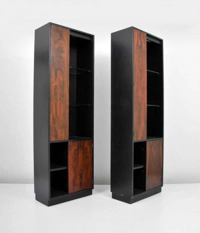 This pair of display cases features an ebonized oak case, rosewood doors and lighted glass shelves. Stunning.

Pieces from this line are often attributed to Harvey Probber, but we cannot confirm that attribution.

(Please note: We try to respond