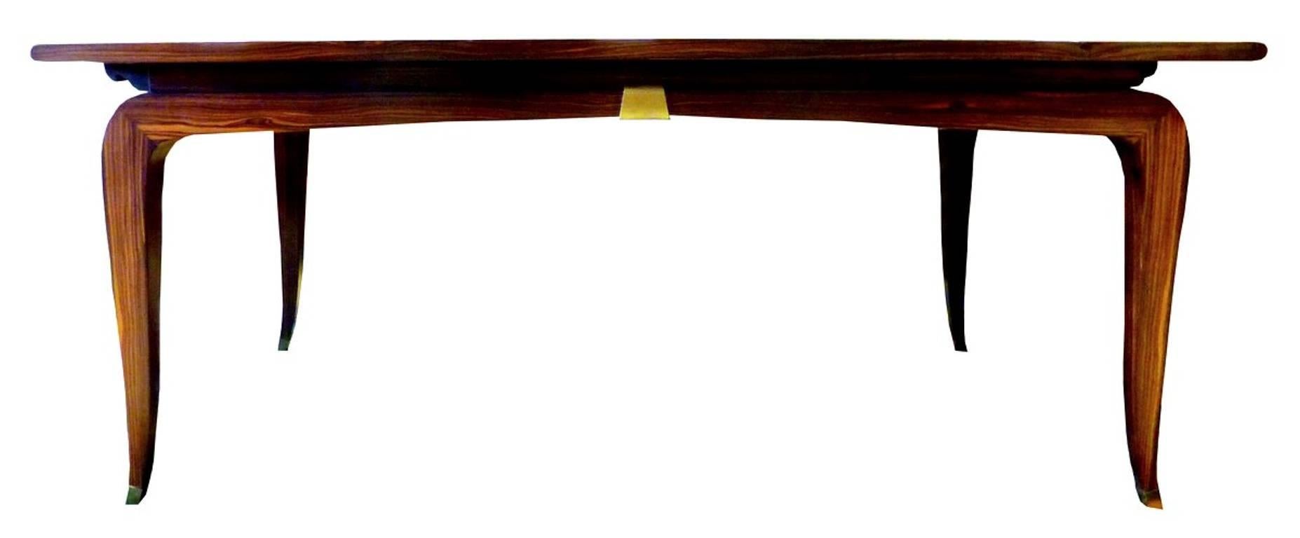 Due to the rare solid Macassar ebony construction, the gold dipped bronze mounts, the use of solid mahogany as a secondary wood, and the signature curve of the legs, we attribute this fine desk to celebrated French designers André Domin and Marcel