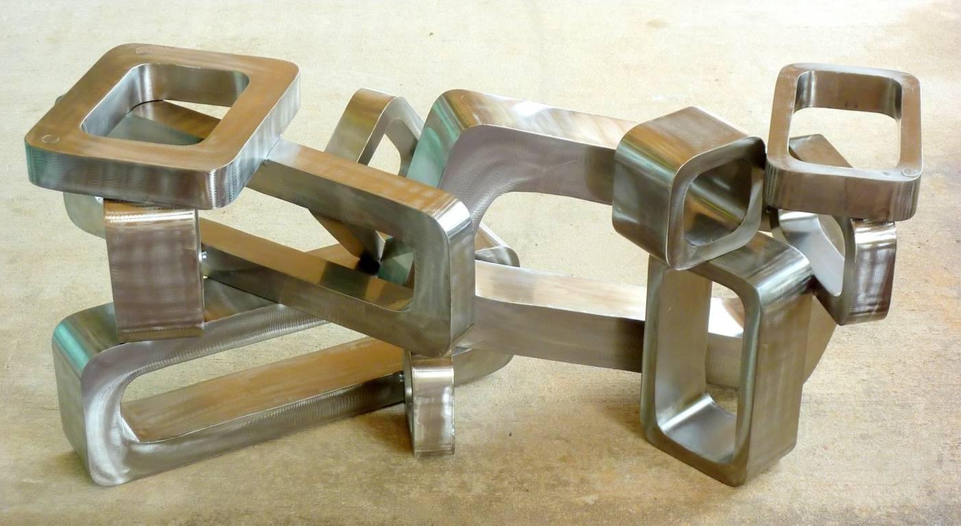 A rare cocktail table by Curtis Jeré consisting of interlocking aluminium rings. Signed and dated 2010. Also works brilliantly as a sculpture in either horizontal or vertical orientation.

(Please note: We try to respond to messages within
