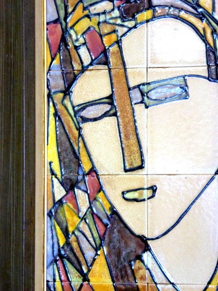 A 1950s Harris Strong composition in his most desirable cubist style. Made of 12 high-fired, hand-painted ceramic tiles in tones of blue, ochre, yellow, brown and white. Mounted on Masonite and presented in its original frame. Original paper label