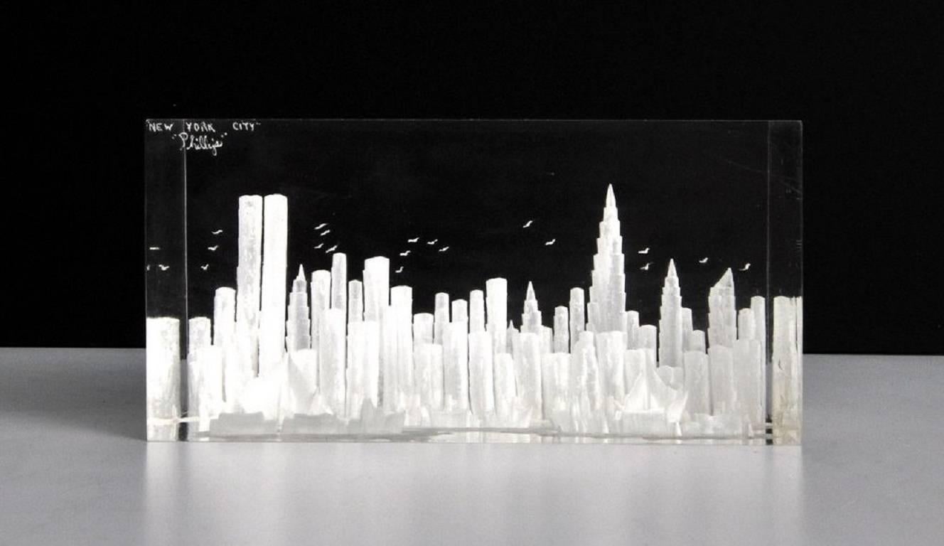 New York City, replete with the Twin Towers, Chrysler Building, sailboats, and gulls, captured in a block of lucite. Signed indistinctly.

We have an extensive selection of vintage Lucite. If you are looking for a special piece or a specific