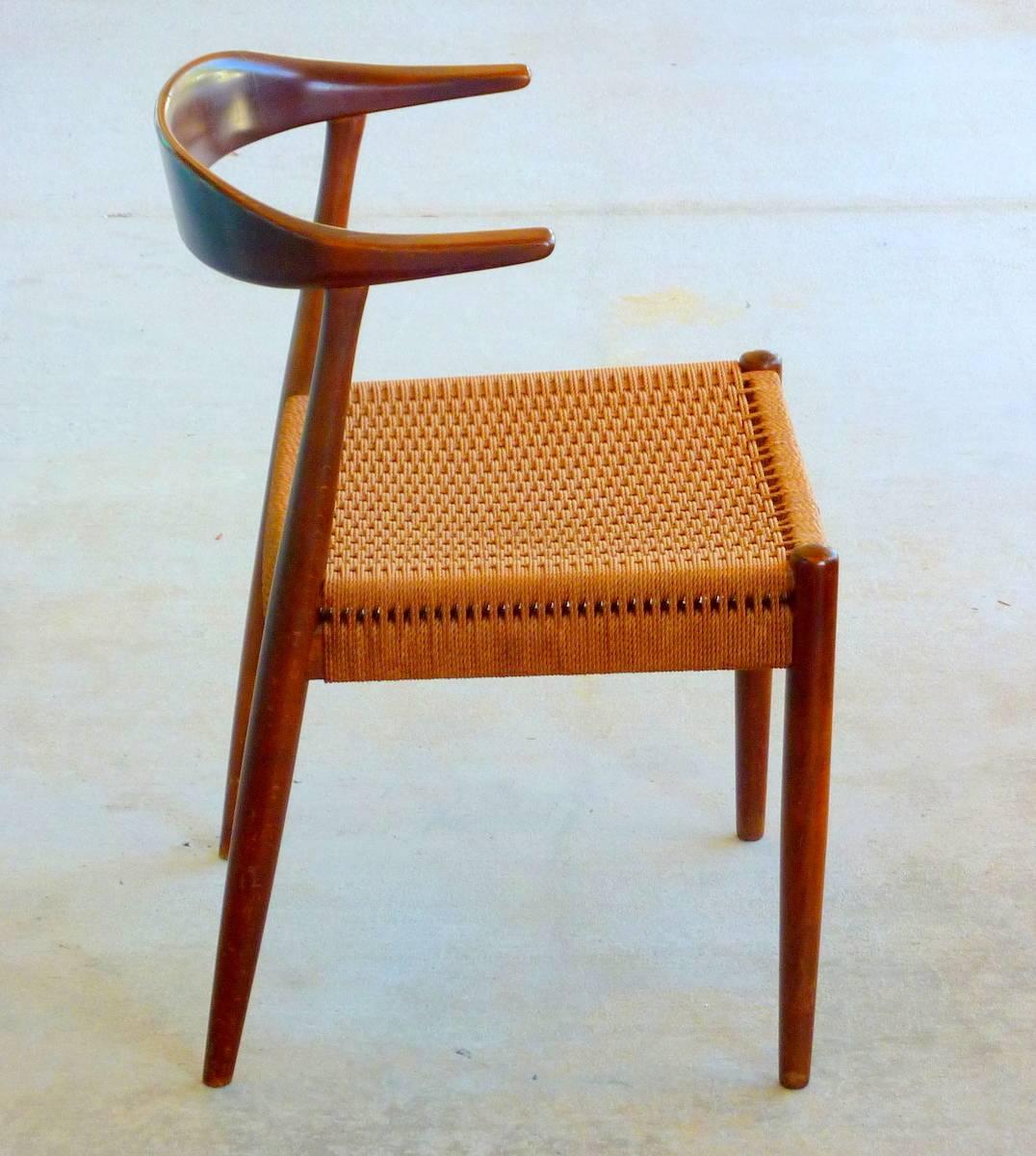 'The Chair' by Hans Wegner is a design Classic. This marvelous Mid-Century version by DUX features a solid walnut frame and woven papercord seat. Original paper label has come off but has been retained.

Woven papercord (aka Danish cord) is among