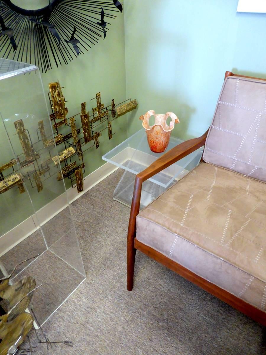 A delightful occasional table made of semi-opaque Lucite in the shape of the letter 