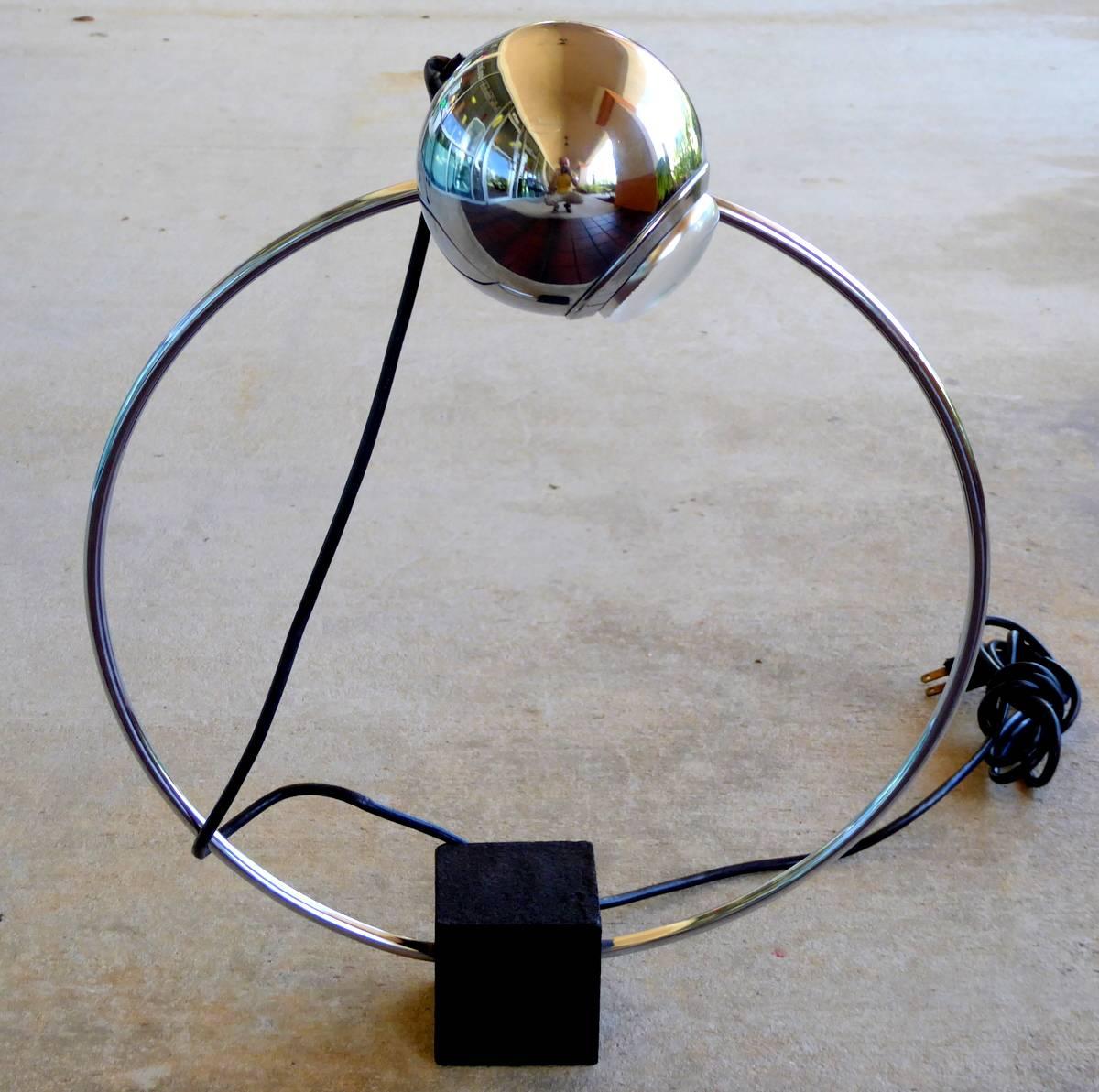 A rare chrome eyeball lamp featuring a heavy base and an orb that swivels and orbits a circular path. In the style of Kovacs, Sonneman, and Koch-Lowy.

A few important notes about all items available through this 1stdibs dealer:

1. We list all our
