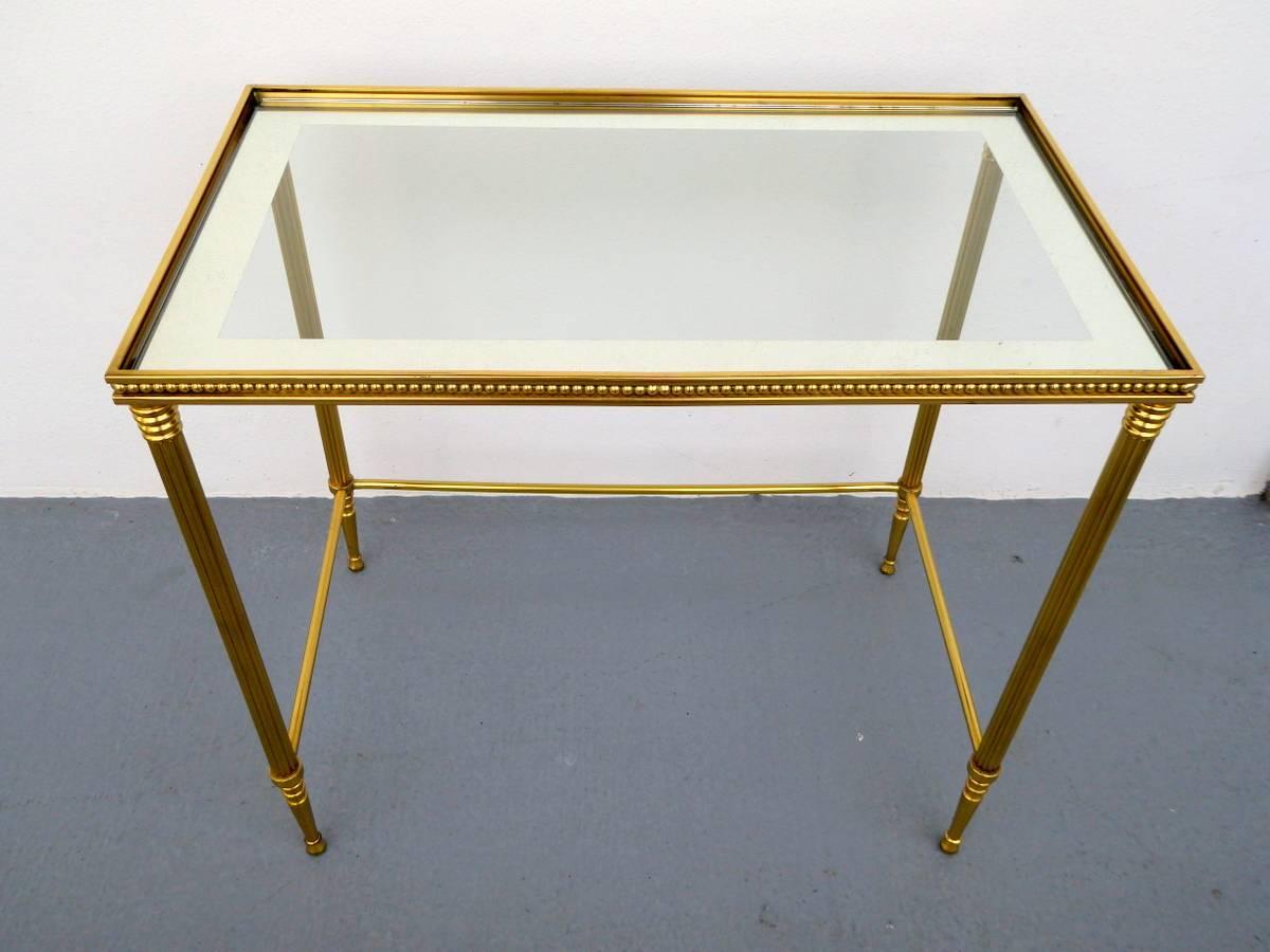 A sublimely elegant Hollywood Regency side table by Maison Jansen. Reeded bronze frame and smoked glass top with mirrored borders.

A few important notes about all items available through this 1stdibs dealer:

1. We list all our items as being in