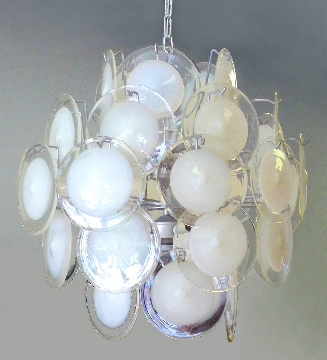 Gino Vistosi's fanciful chandeliers made in Italy during the 1960s are hard to find. This marvelous example features 36 milk and clear handblown Murano glass discs.

(Please note: We try to respond to messages within minutes, but in no event does it