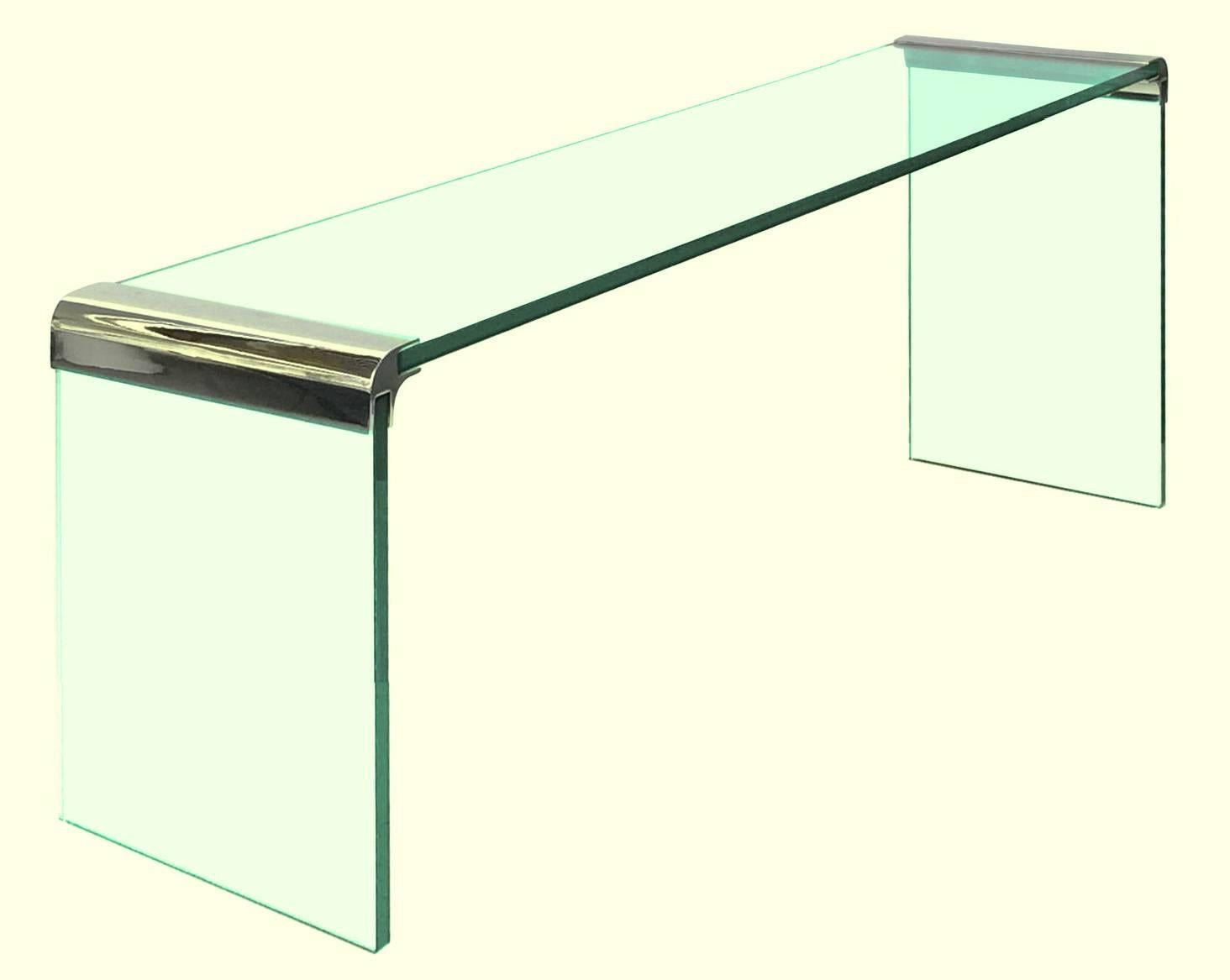 A selection of elegant waterfall console tables designed by Leon Rosen for The Pace Collection. Thick glass slabs connected by corners of solid nickel that are either polished to a mirror finish or gold-plated. Stunning.

These pieces disassemble