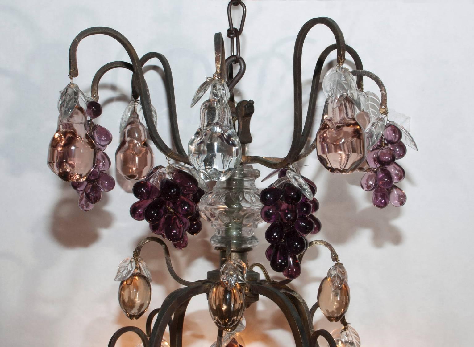Truly symbolizing a bouquet of plenty, this 19th century chandelier is French made and draped in a variety of elegant colored Baccarat crystal fruit. Apples, pears and pomegranates all hung amidst bunches of dark purple grapes. An excellent fixture