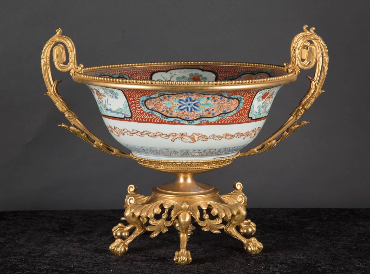 This large Japanese porcelain centerpiece combines 18th century porcelain with 19th century French bronze d’ore. This combination was classic to the period as the French would import the high quality porcelain and later add their own intricate gold