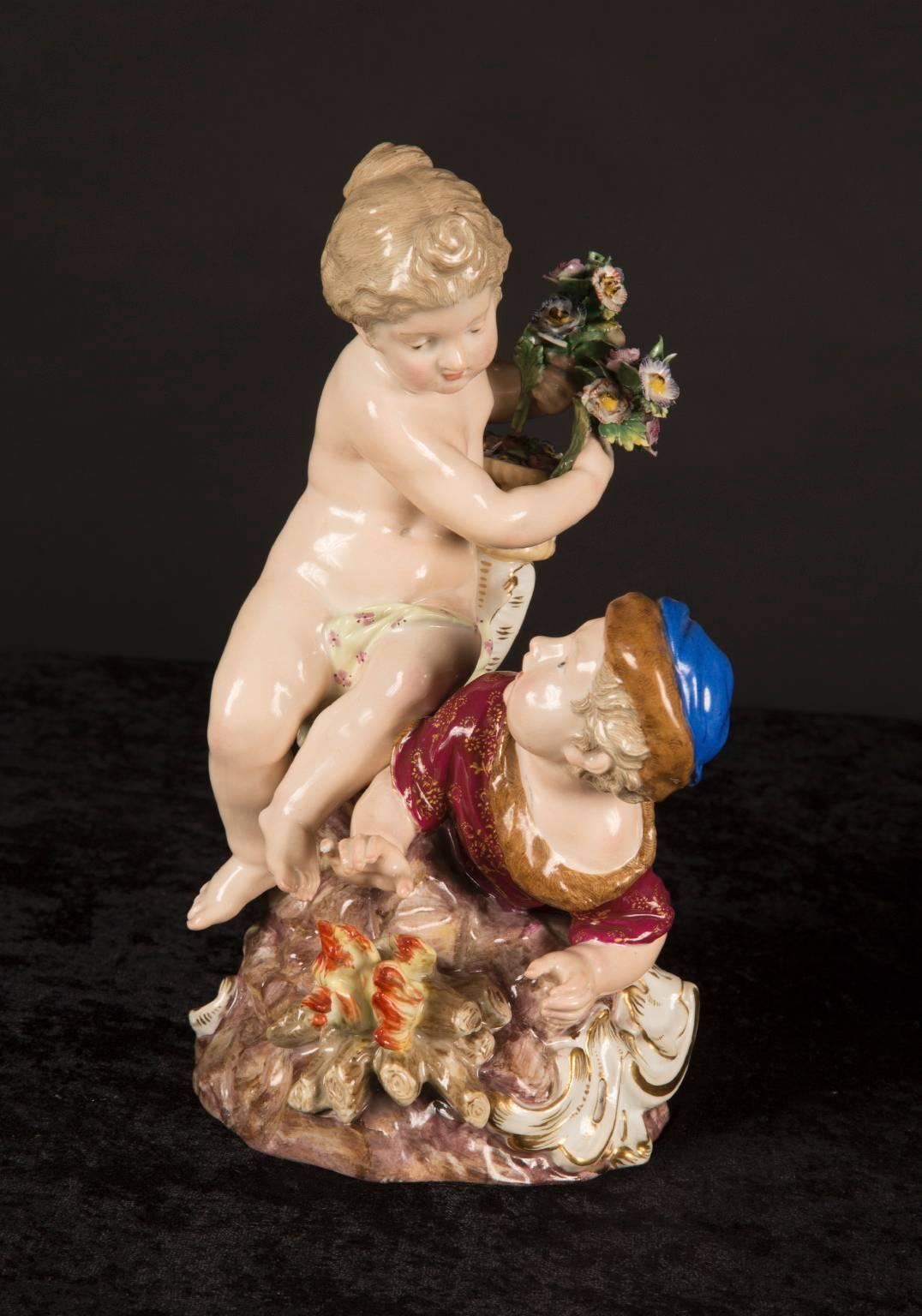 This pair of Meissen figurines depicts four infants, each representative of one of the Four Seasons. Autumn and summer are paired together, with Summer draped in a purple cloth, holding a bunch of grapes. Autumn rests with a bushel of wheat in the