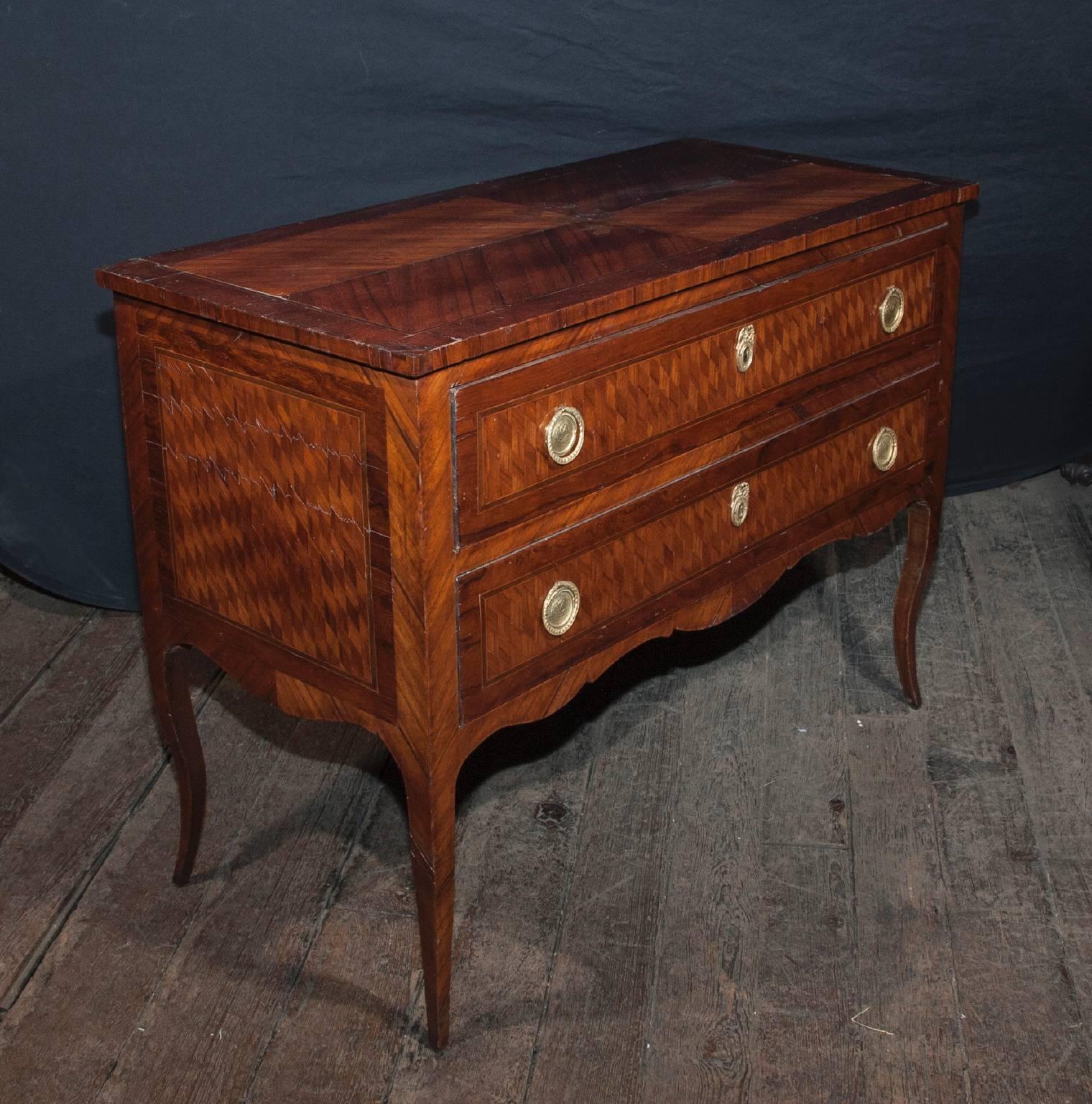 This chest is a two-drawer marquetry chest made in 19th century, France. The marquetry work on this chest is truly magnificent. Additionally, the hardware on the chest features naval ships in the center.